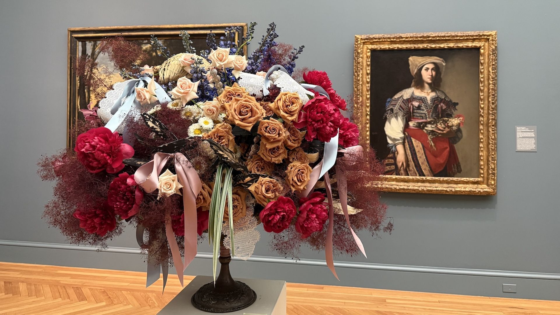 A floral arrangement from Woodside Parker Design, nodding to Massimo Stanzione's Woman in Neapolitan Costume, on show at the Legion of Honor. Photo: Claire Reilly/Axios