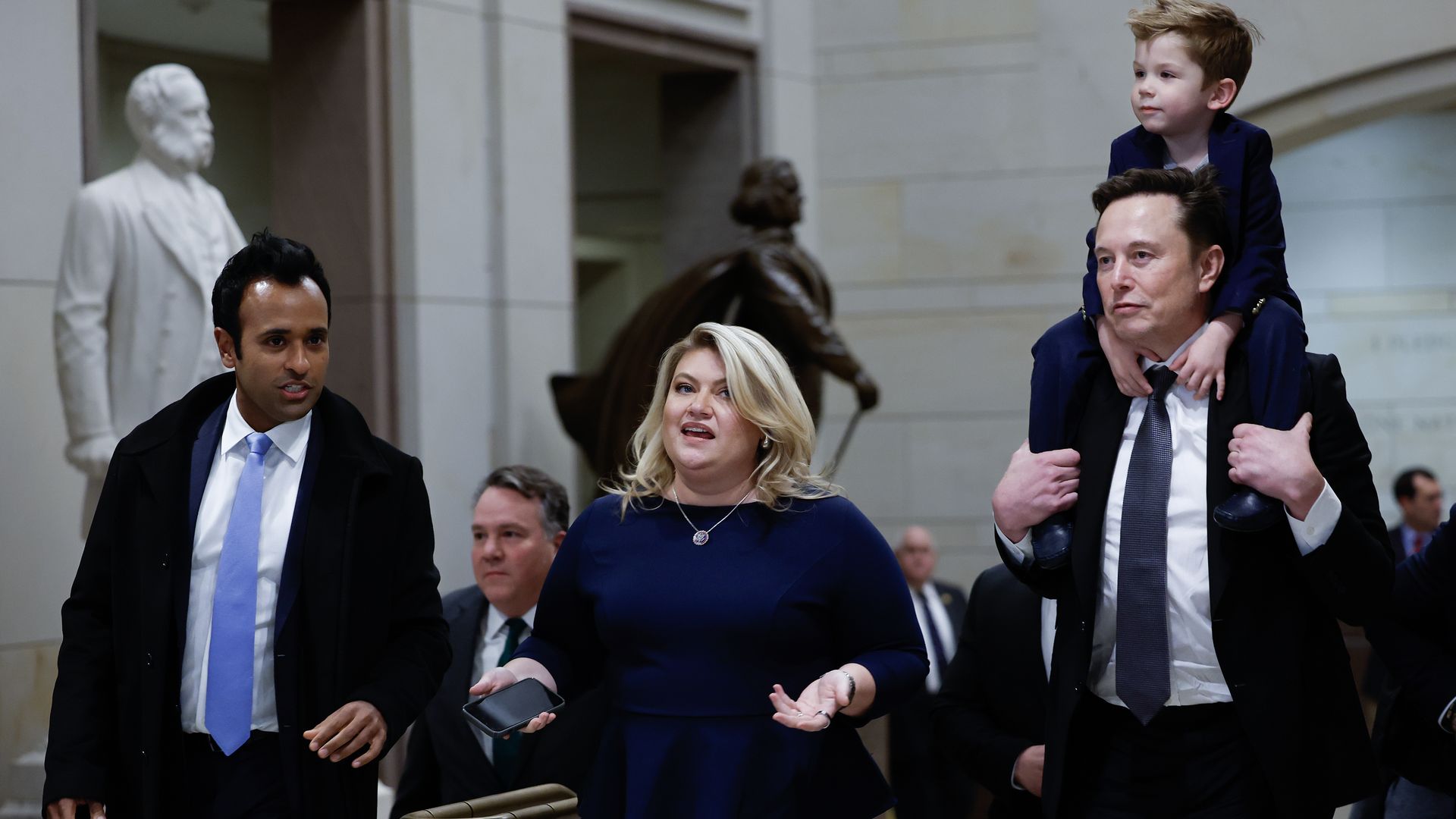 Elon Musk, co-chair of DOGE carries his son on his shoulders at the U.S. Capitol following a meeting with businessman Vivek Ramaswamy, Rep. Kat Cammack, and other members of the U.S. Congress in Washington, DC.