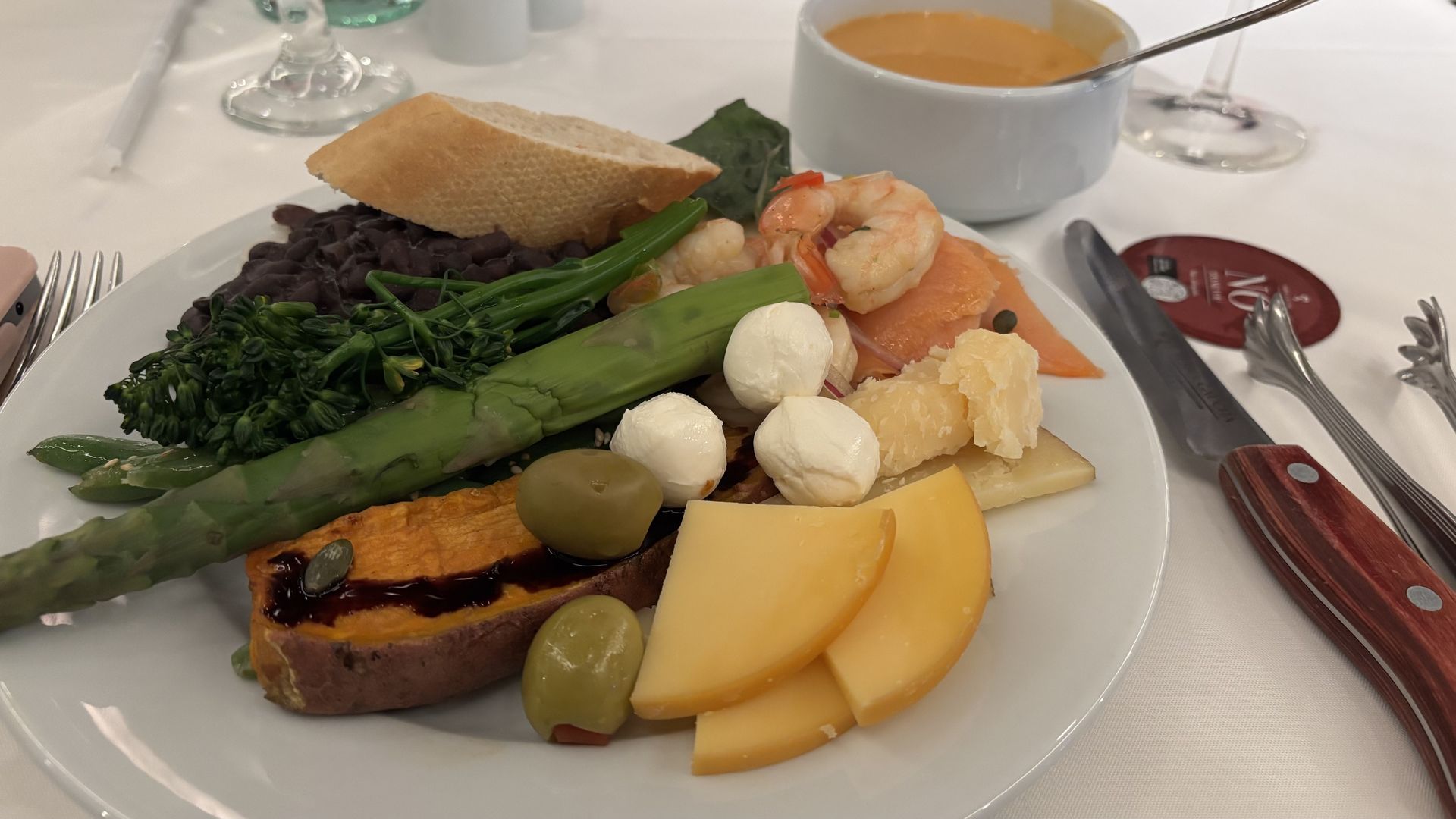 A plate of cheese and vegetables