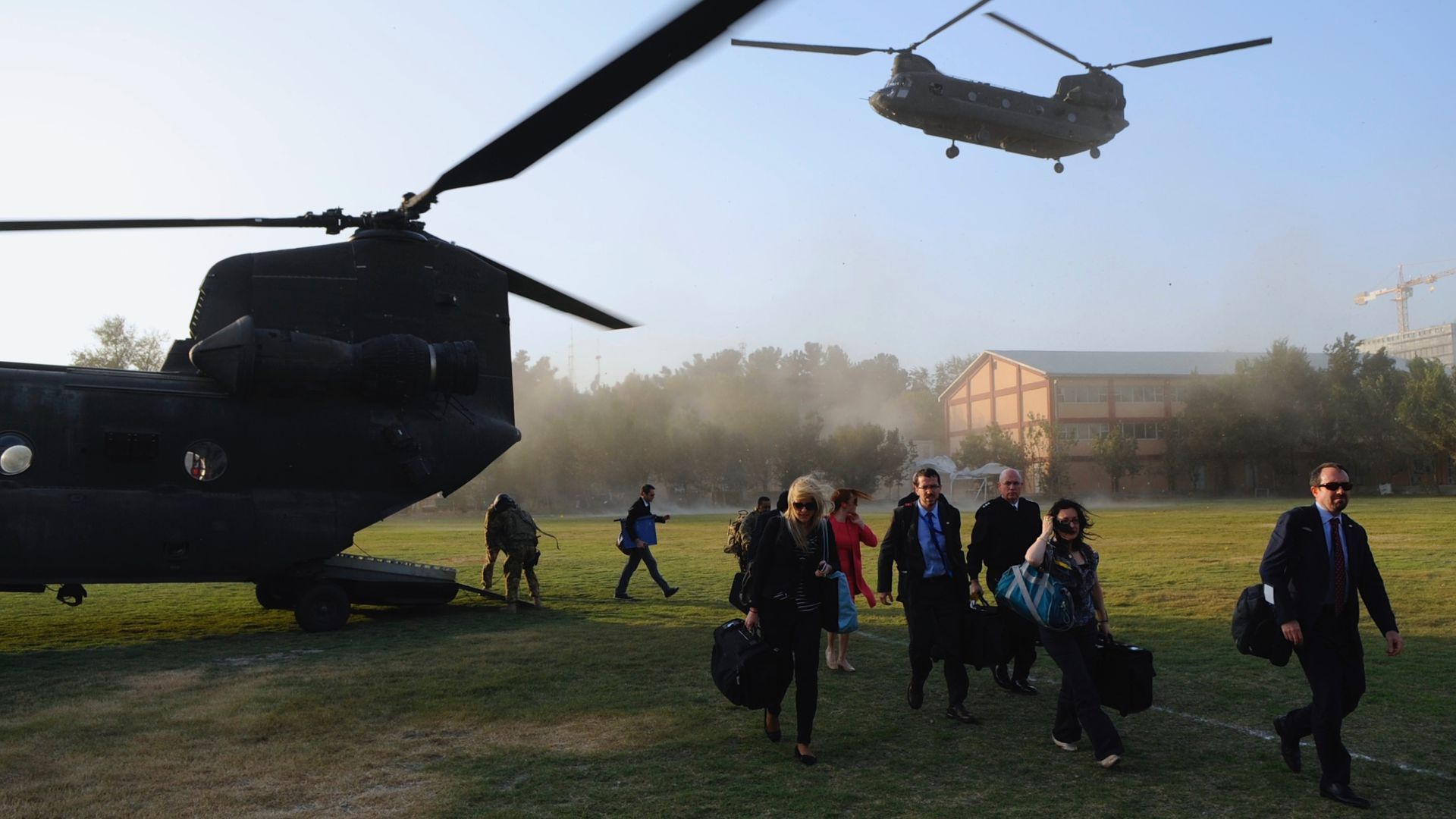 A U.S. delegation is seen windblown around helicopters near the embassy in Kabul from a photo in 2013.