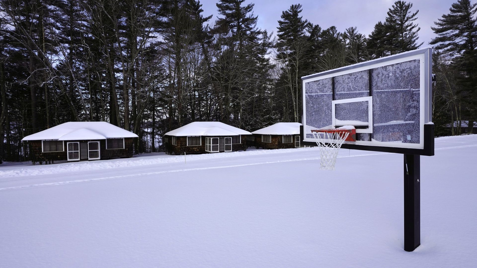 Snow covers a basketball court at Camp Fernwood, a summer camp for girls in Poland, Maine.