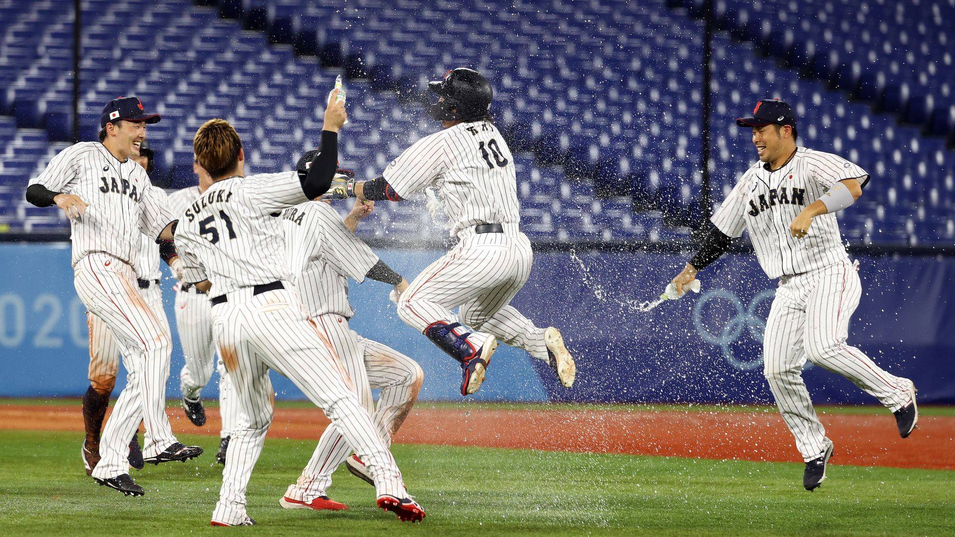 Team Japan celebrates with his teammates after hitting a game-winning single in the tenth inning to defeat Team United States