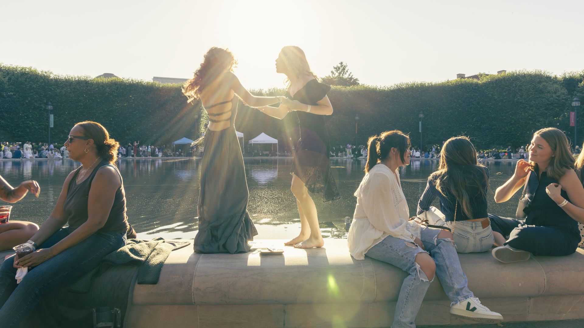 Two women dance at the pond at the National Gallery for Jazz in the Garden