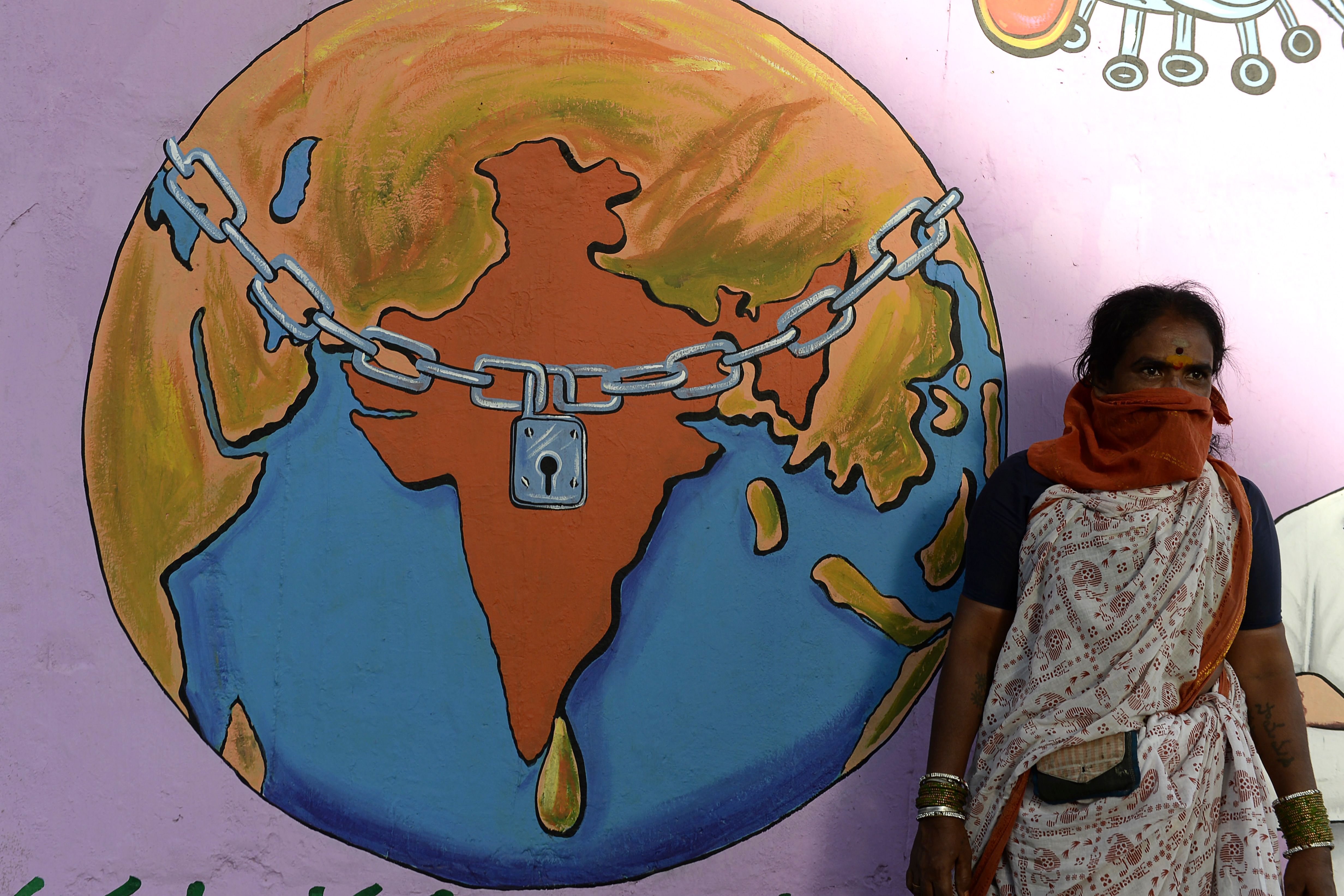 Graffiti depicting a world under lockdown, during an Indian lockdown against COVID-19, on the outskirts of Hyderabad on May 29
