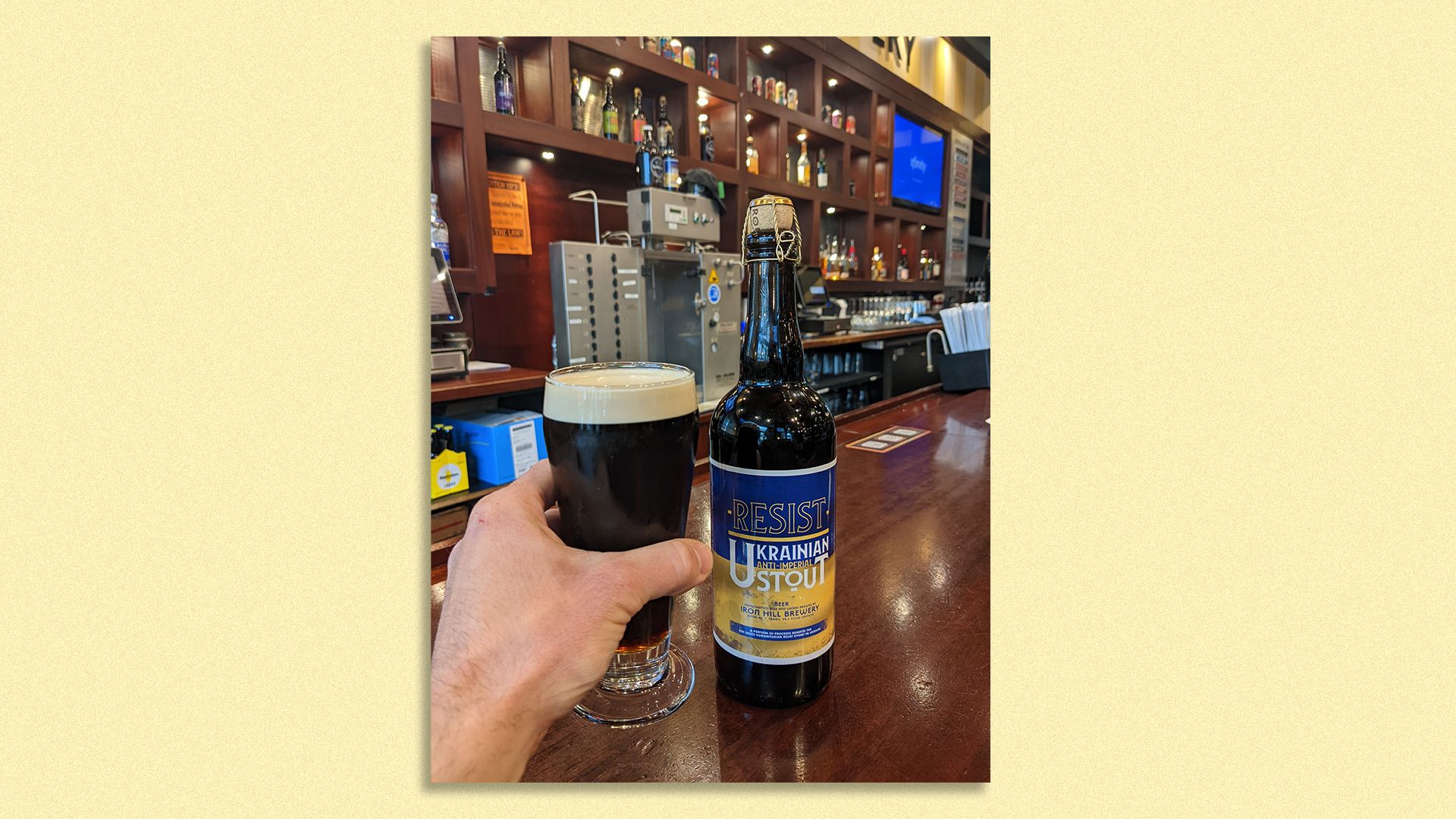 A glass of Rye of the Tiger and a bottle of RESIST are at Iron Hill Brewery in Chestnut Hill. Photo: Mike D’Onofrio/Axios