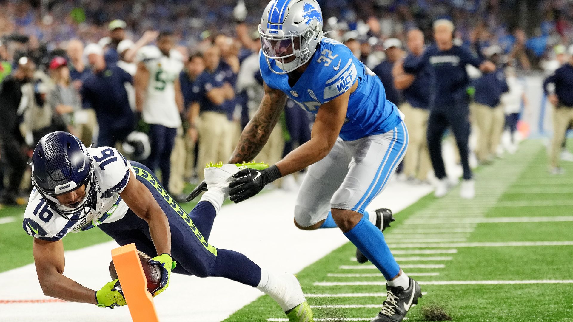 Seattle wide receiver Tyler Lockett scores the game-winning touchdown in overtime yesterday.