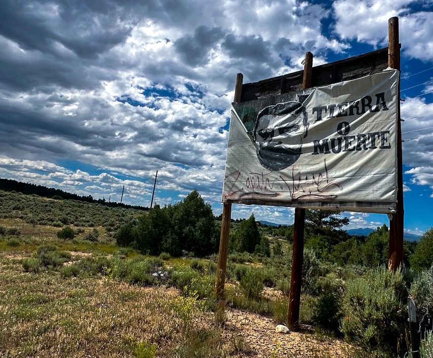 The 1960s-era "Tierra o Muerte" poster greets visitors coming into Tierra Amarilla, New Mexico.
