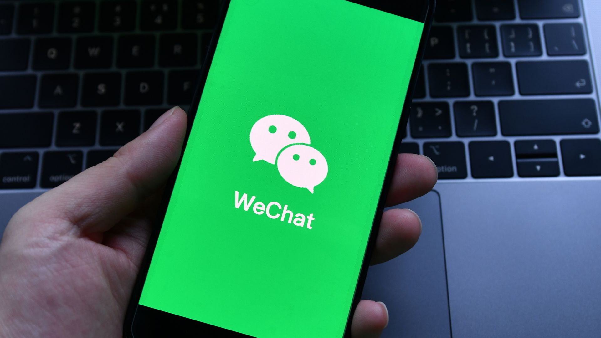 An illustration of the WeChat logo on a phone screen. 