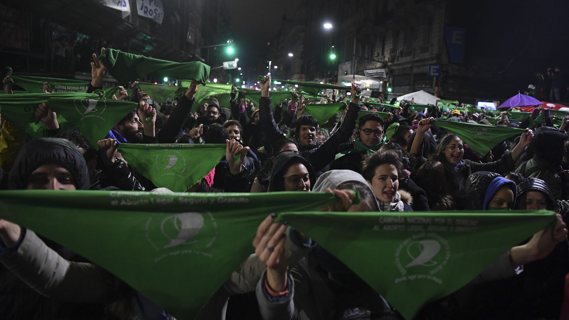 Argentine protestors hold up green bandanas