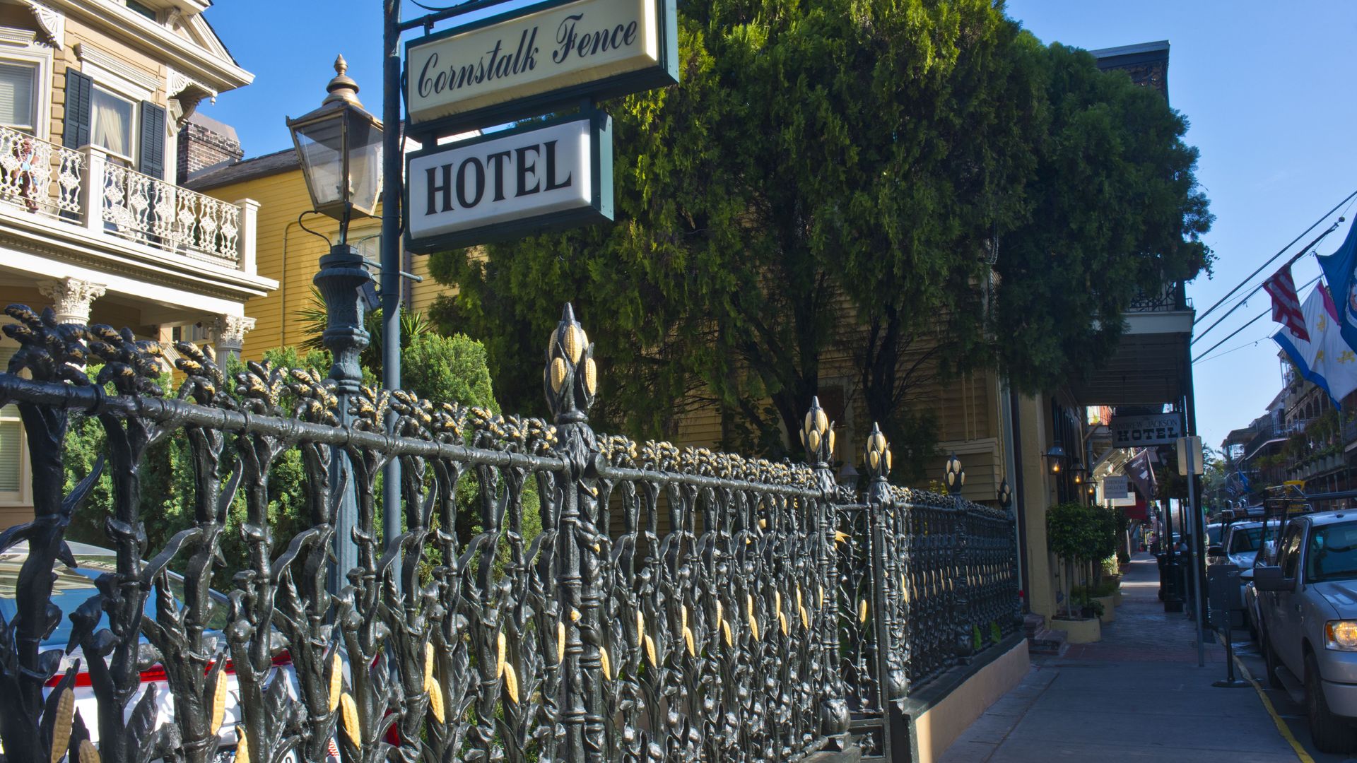 A photo of the Cornstalk Fence Hotel which focuses on the cornstalk-styled iron fence out front.