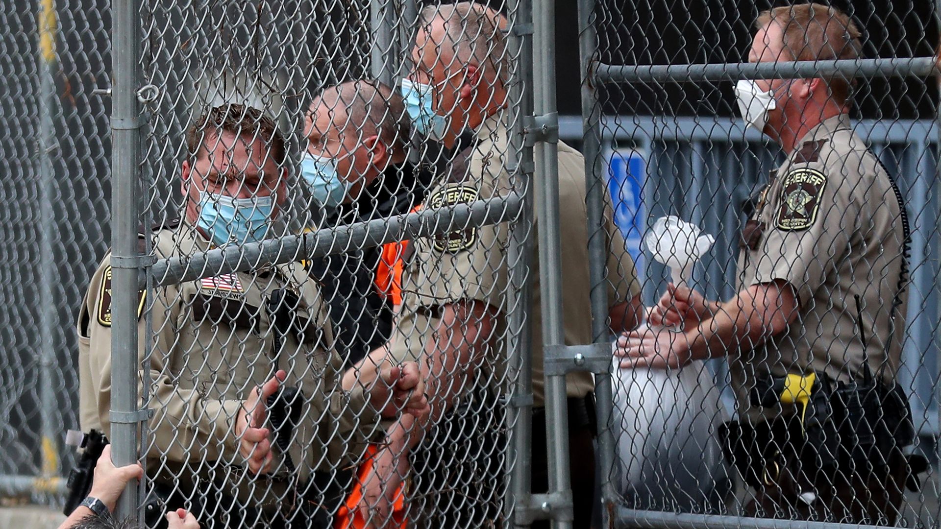 Picture of police officers escorting derek chauvin