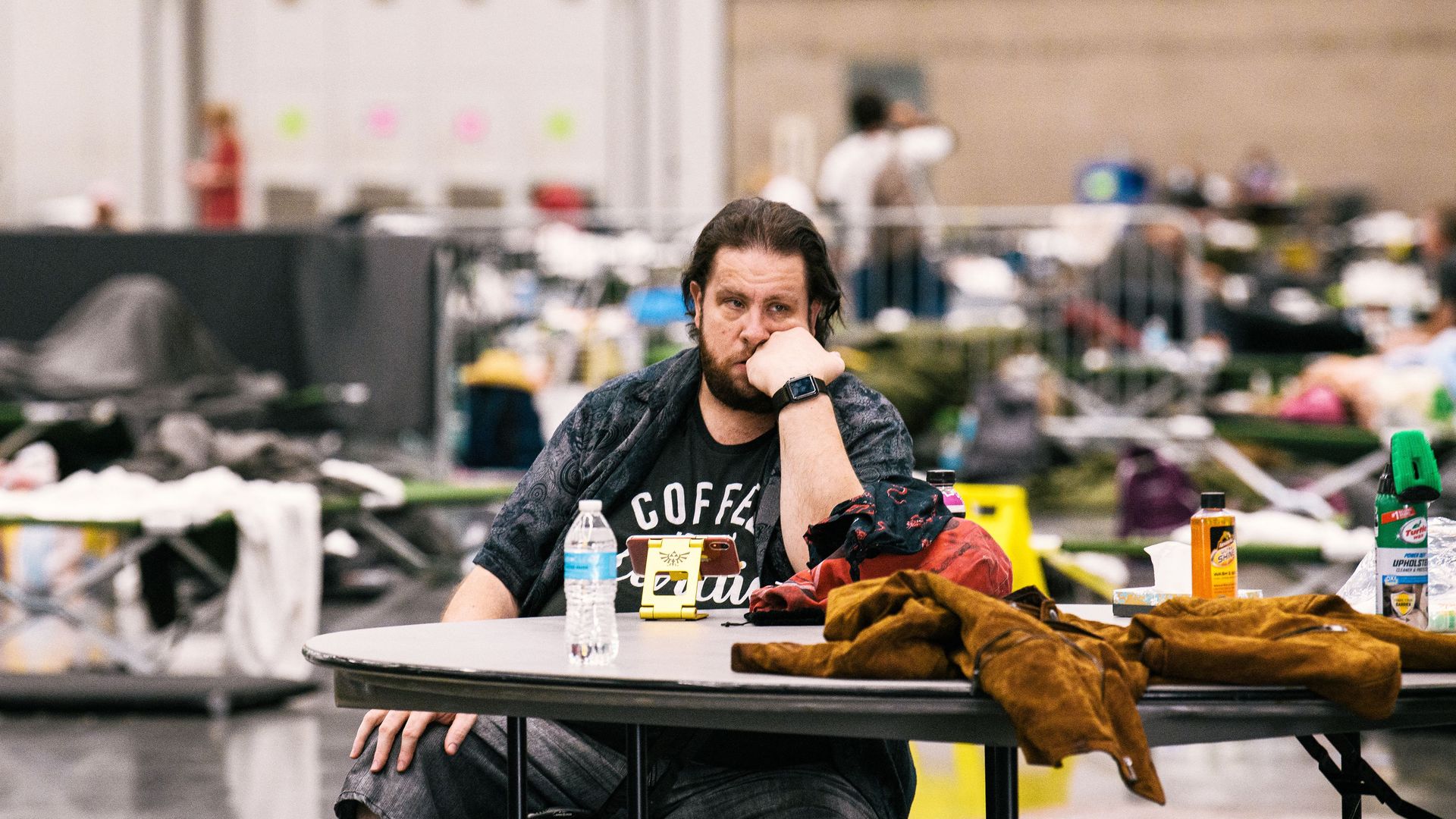 Man sits at a table in a cooling center during a heat wave.