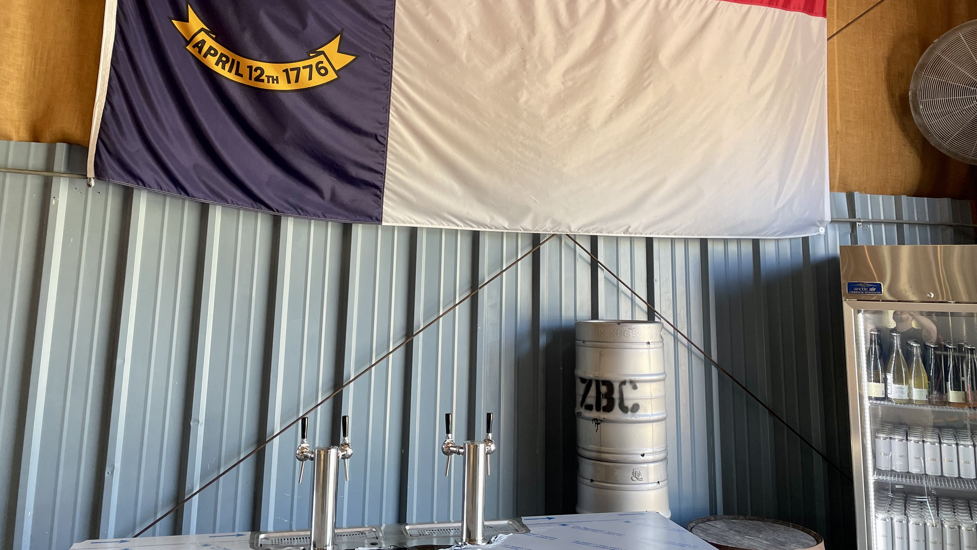 A North Carolina state flag hangs above the taps at Zillicoah brewery outside Asheville.
