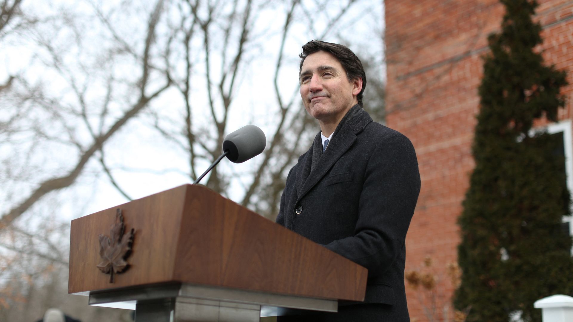 Justin Trudeau speaks at a lectern outdoors