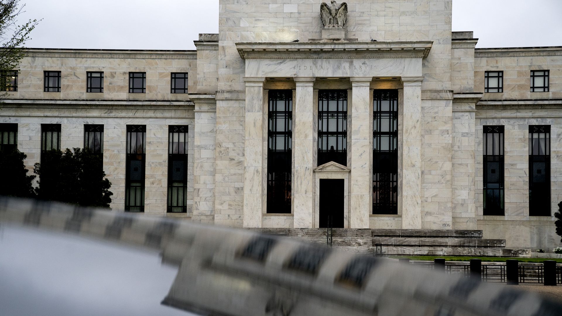 The Marriner S. Eccles Federal Reserve building reflected on a vehicle in Washington, D.C.