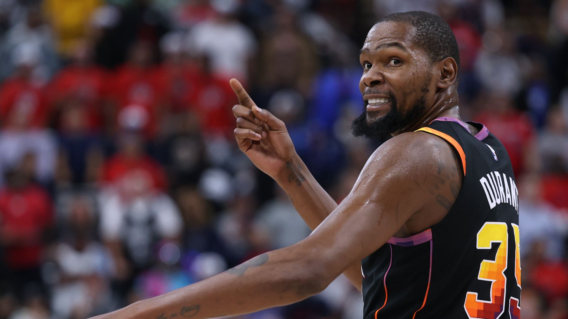 Kevin Durant smiles and points during a game Phoenix Suns game. 