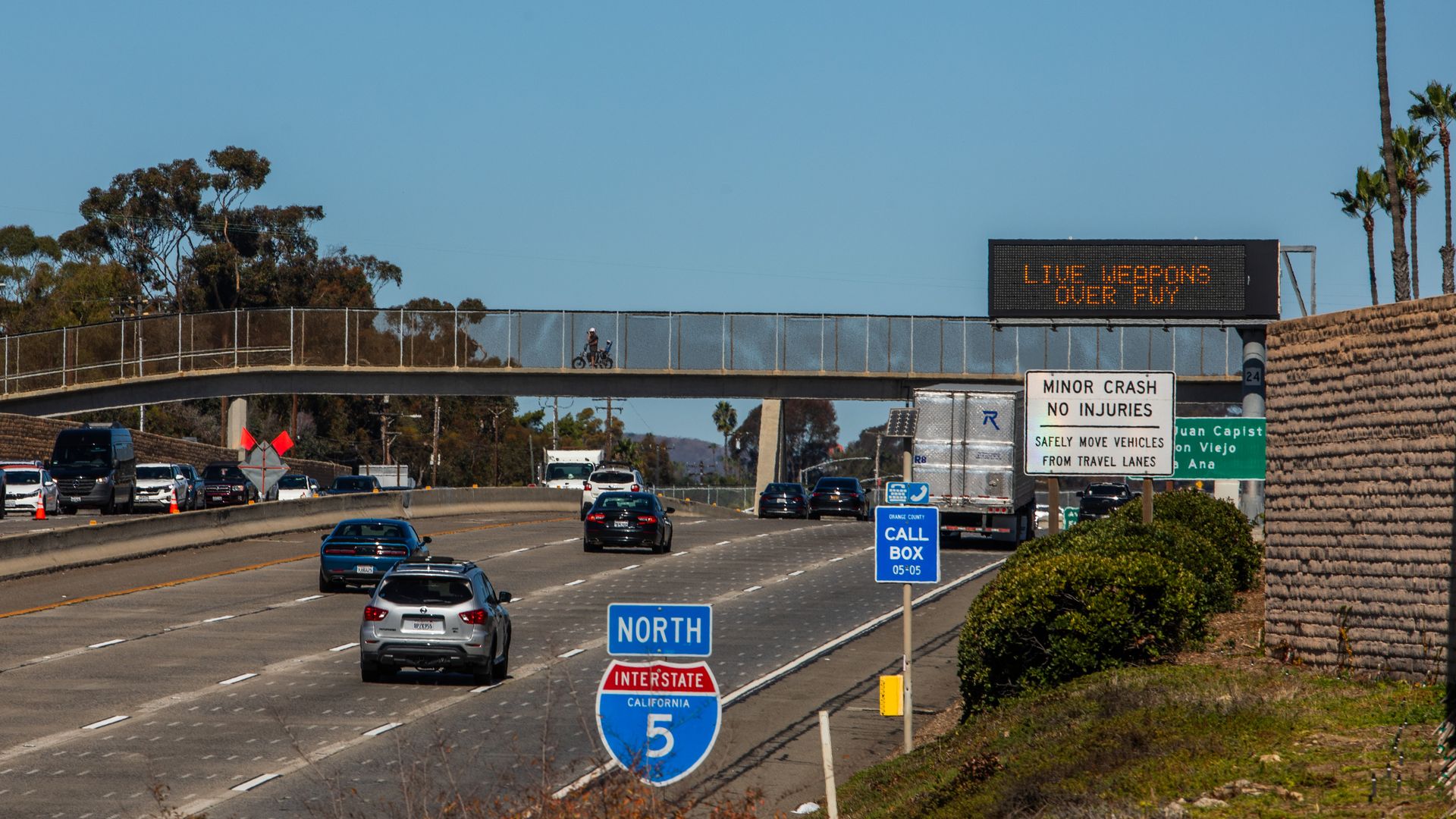 Sign alerting drivers about the closure of the 5 Freeway on October 18, 2025 in San Clemente, California, saying "LIVE FIRE WEAPONS OVER FREEWAY"