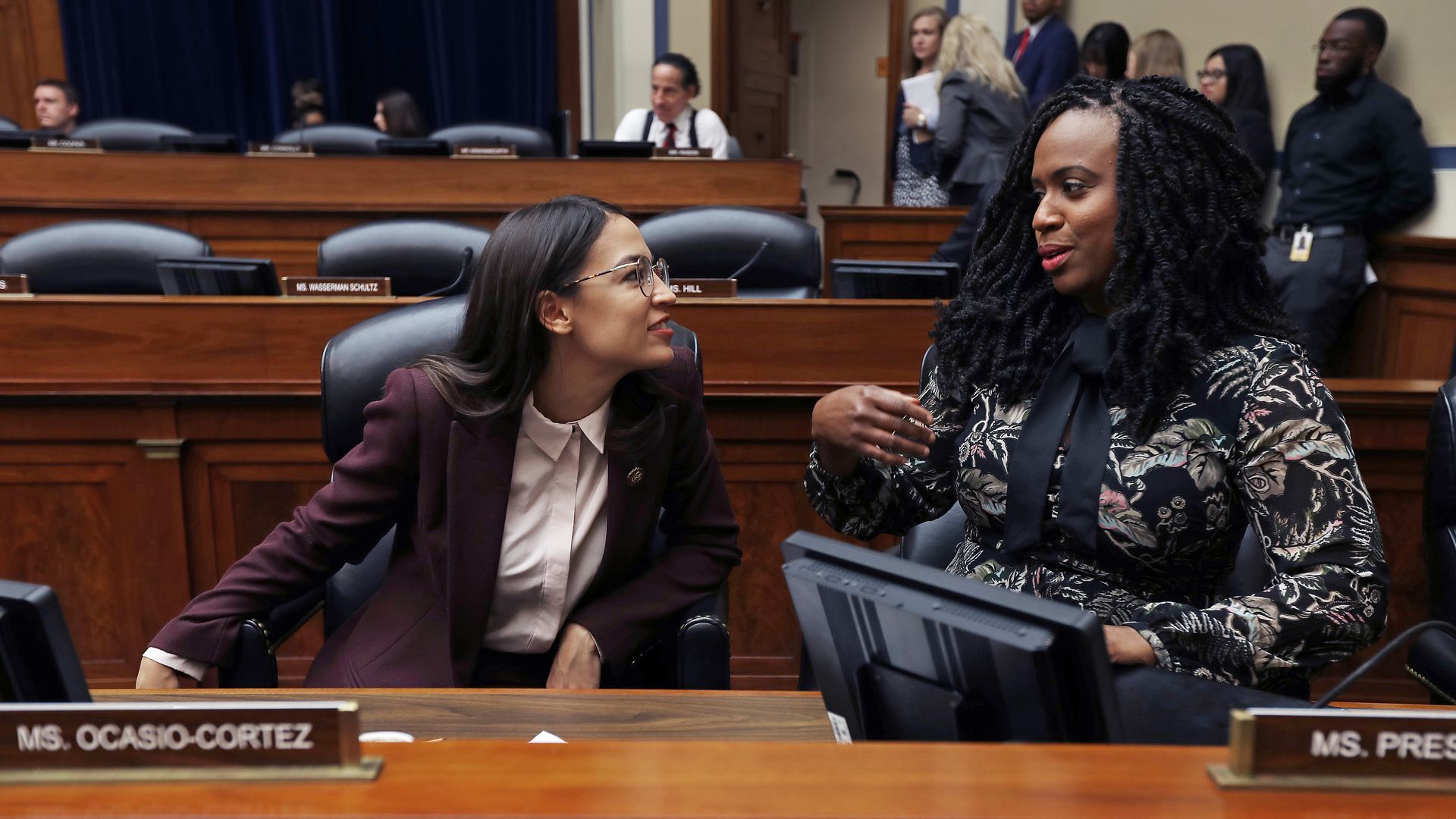 Reps. Alexandria Ocasio-Cortez and Ayanna Pressley are seen speaking during a congressional hearing.