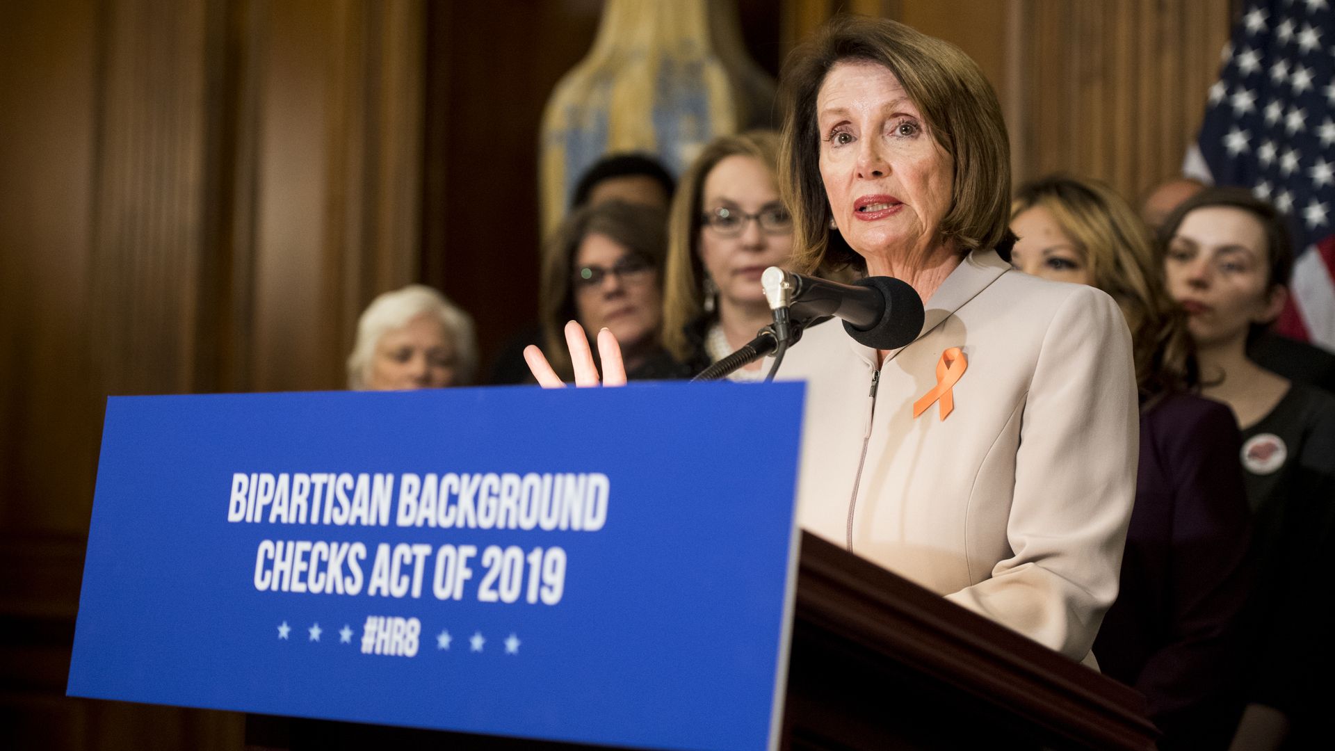 Nancy Pelosi at a podium of bipartisan background checks press conference