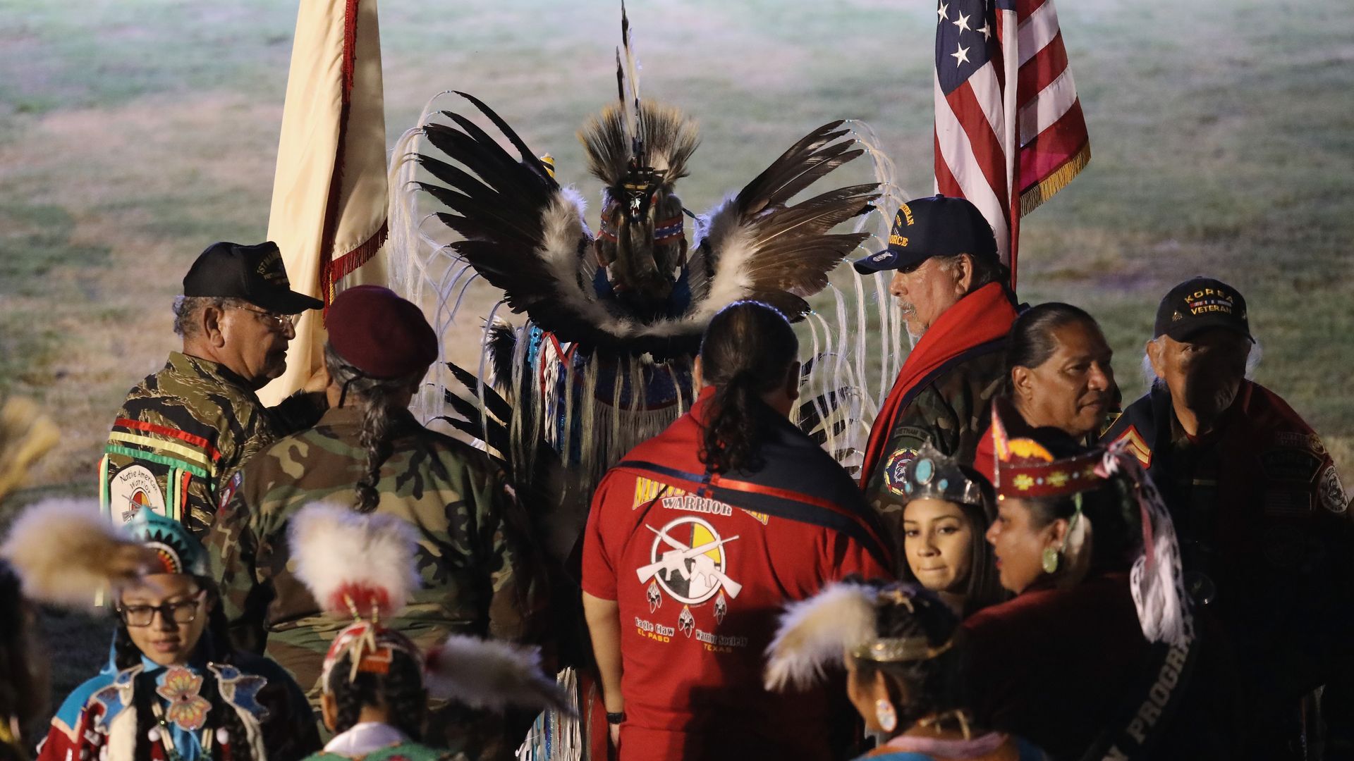 Native American veterans carry U.S. and tribal flags before entering the "Rocking the Rez" Pow Wow in 2016 in Ysleta del Sur Pueblo, Texas.  Photo: John Moore/Getty Images