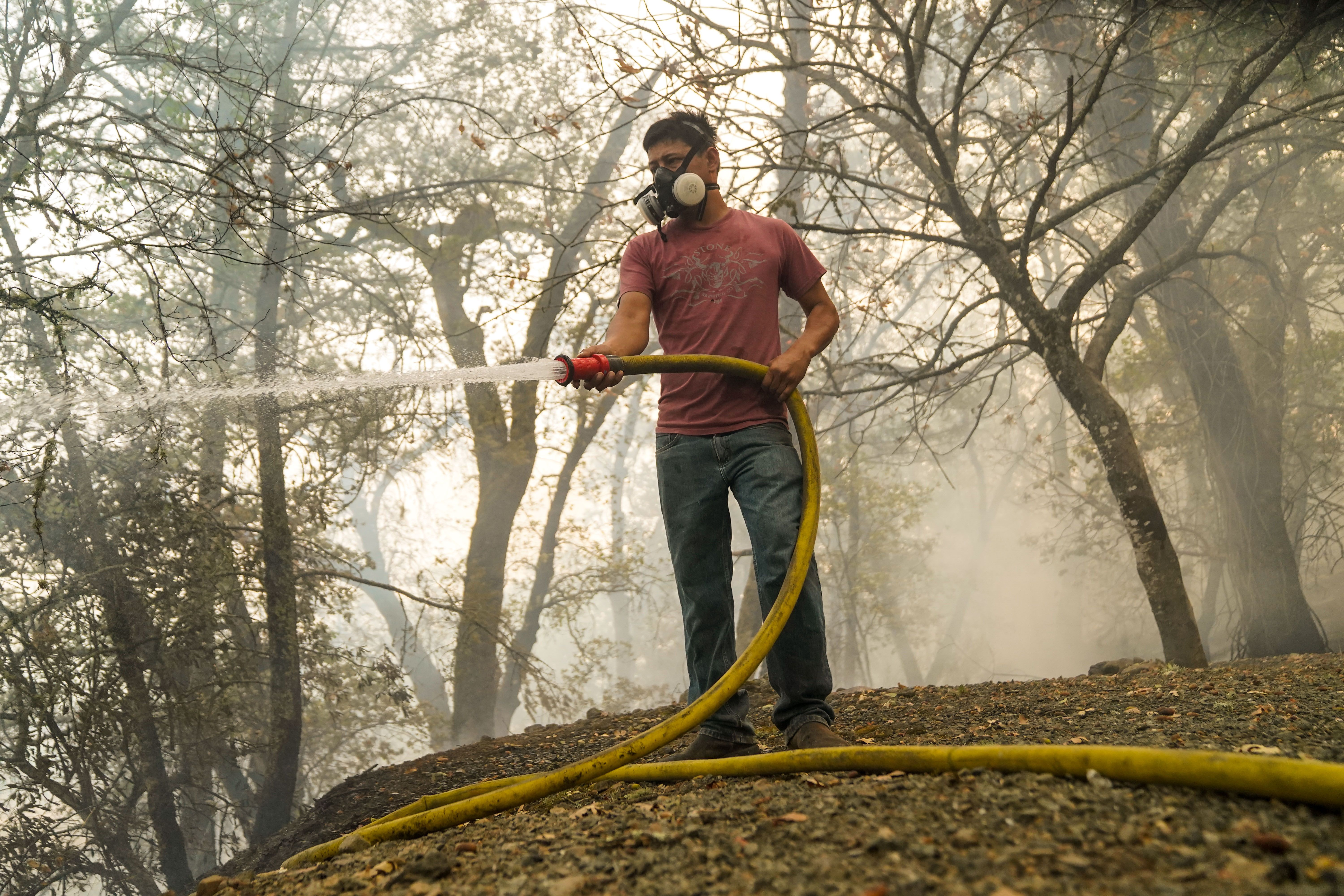  A local resident who didnt want to be named wets down hotspots near a home along CA-128 during the Glass Fire in Napa County on Tuesday, Sept. 29, 2020 in Calistoga, CA. 