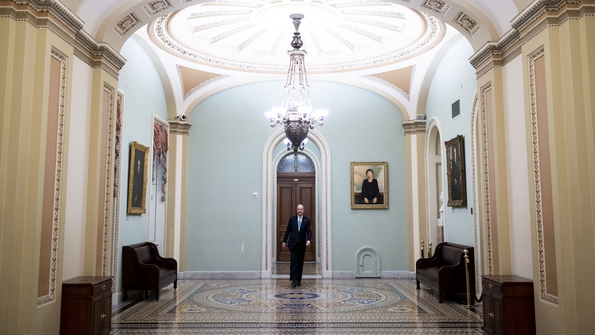 In this image, a man walks in a doorway on Capitol Hill.