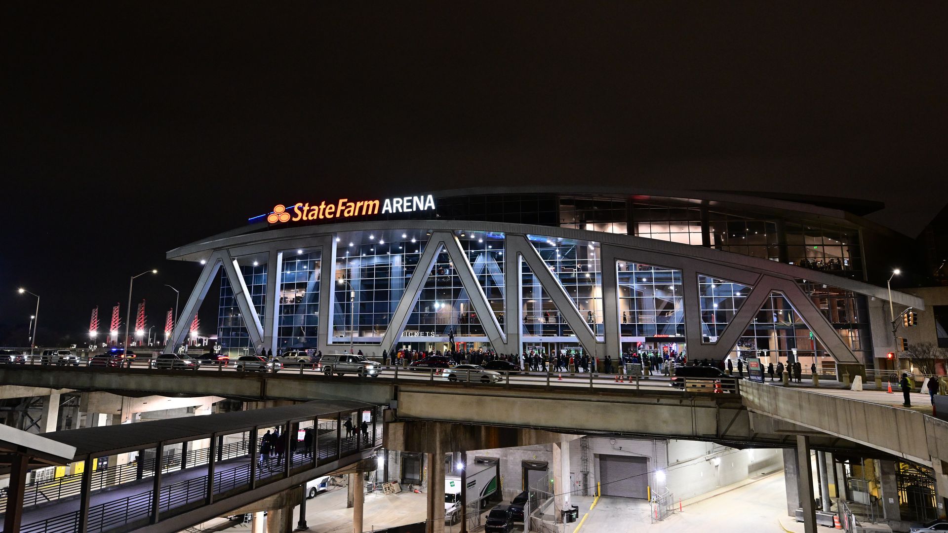 An exterior shot of State Farm Arena, with "Atlanta" spelled out in front of the arena's facade against a night sky.