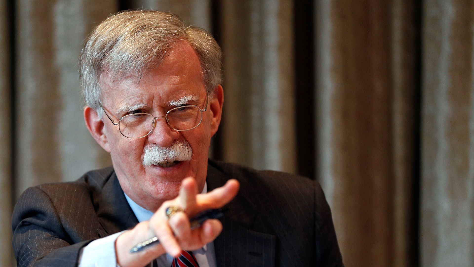 U.S. National Security Advisor, John Bolton, gestures as he meets with journalists during a visit to London
