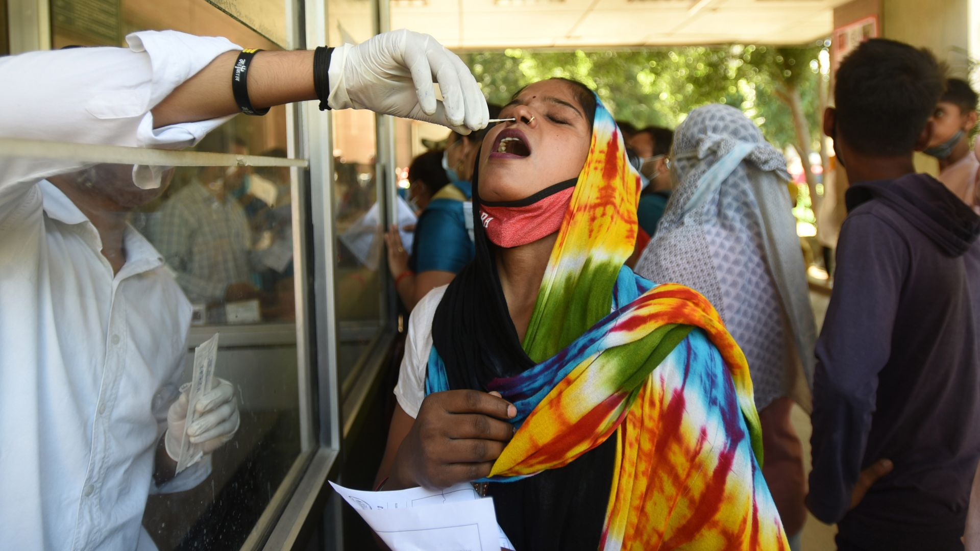A health care worker administering a coronavirus test in Noida, India, on Oct. 4.