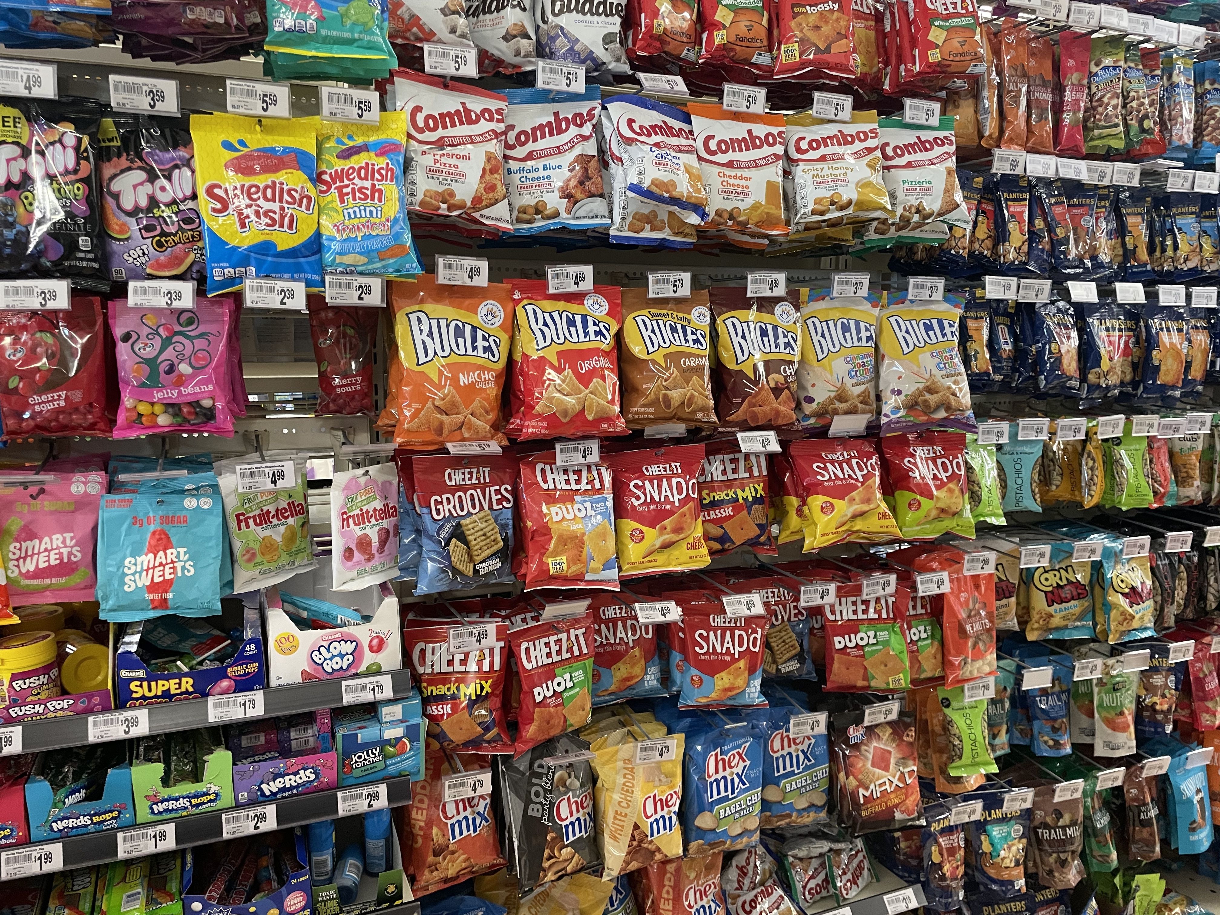A wall of snacks displayed in a convenience store.