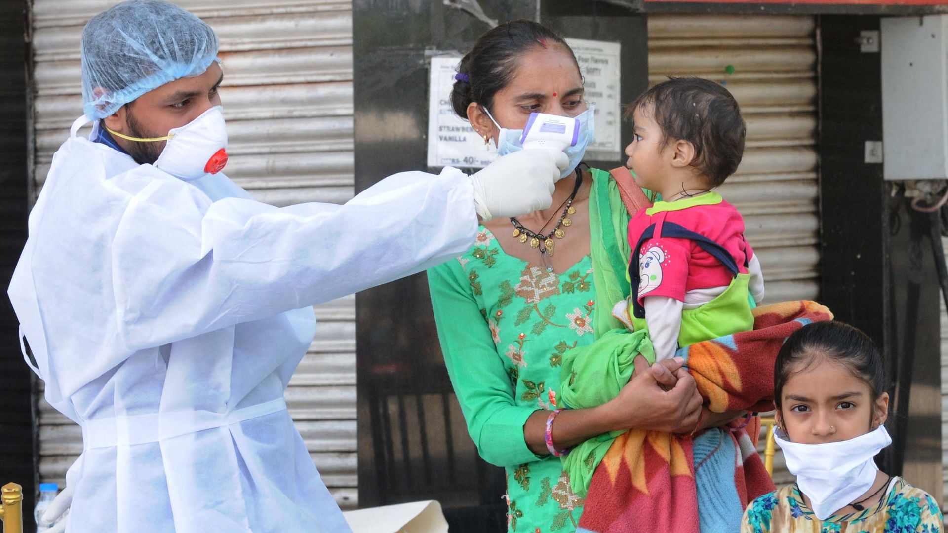A medical worker checks a child's temperature.