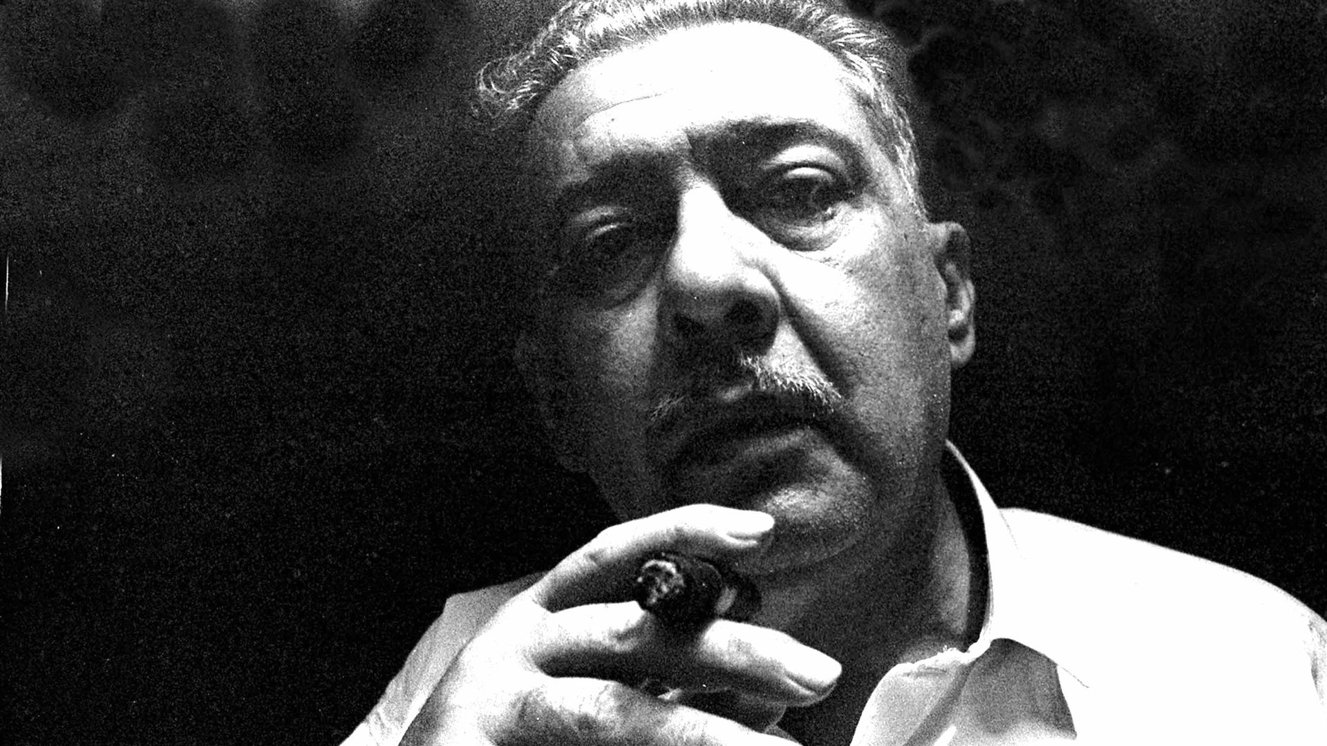 José Lezama Lima with a cigar.