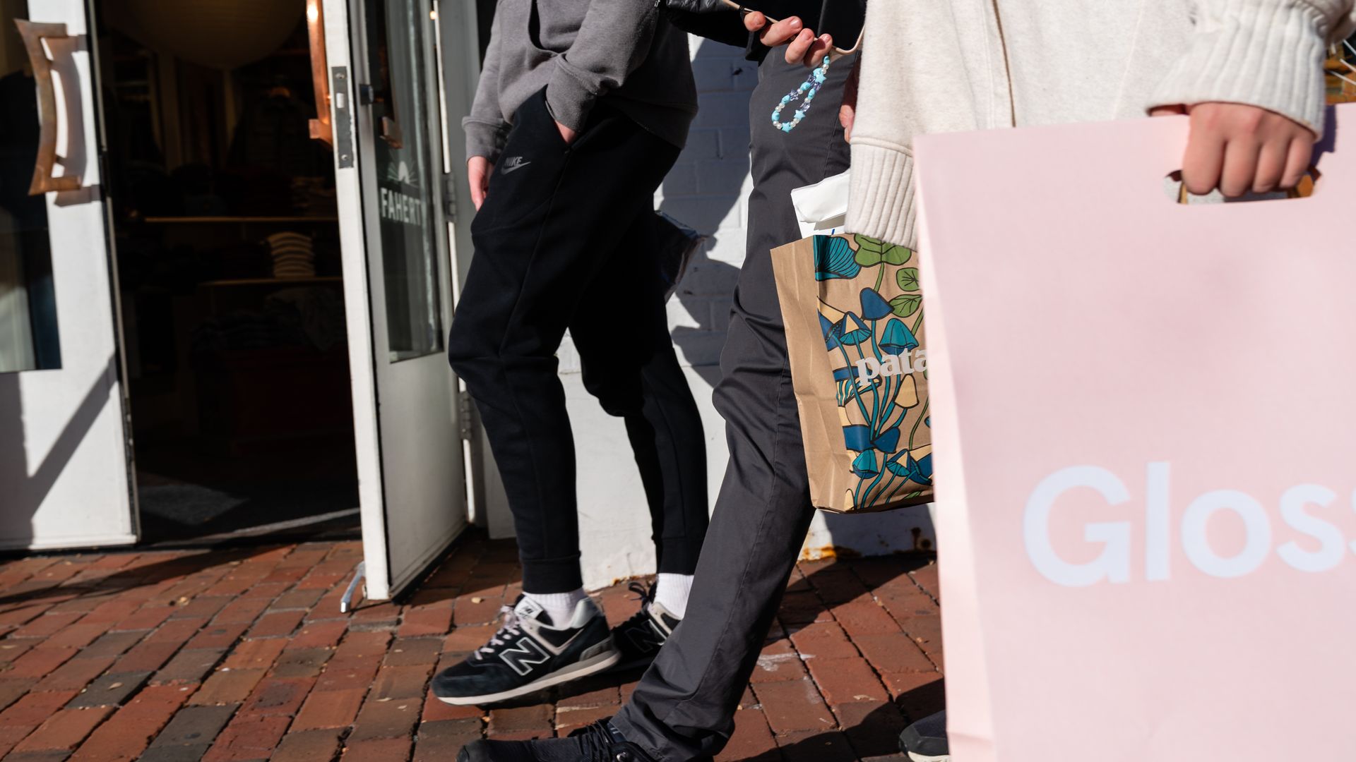 Retail shoppers walk in Georgetown holding shopping bags