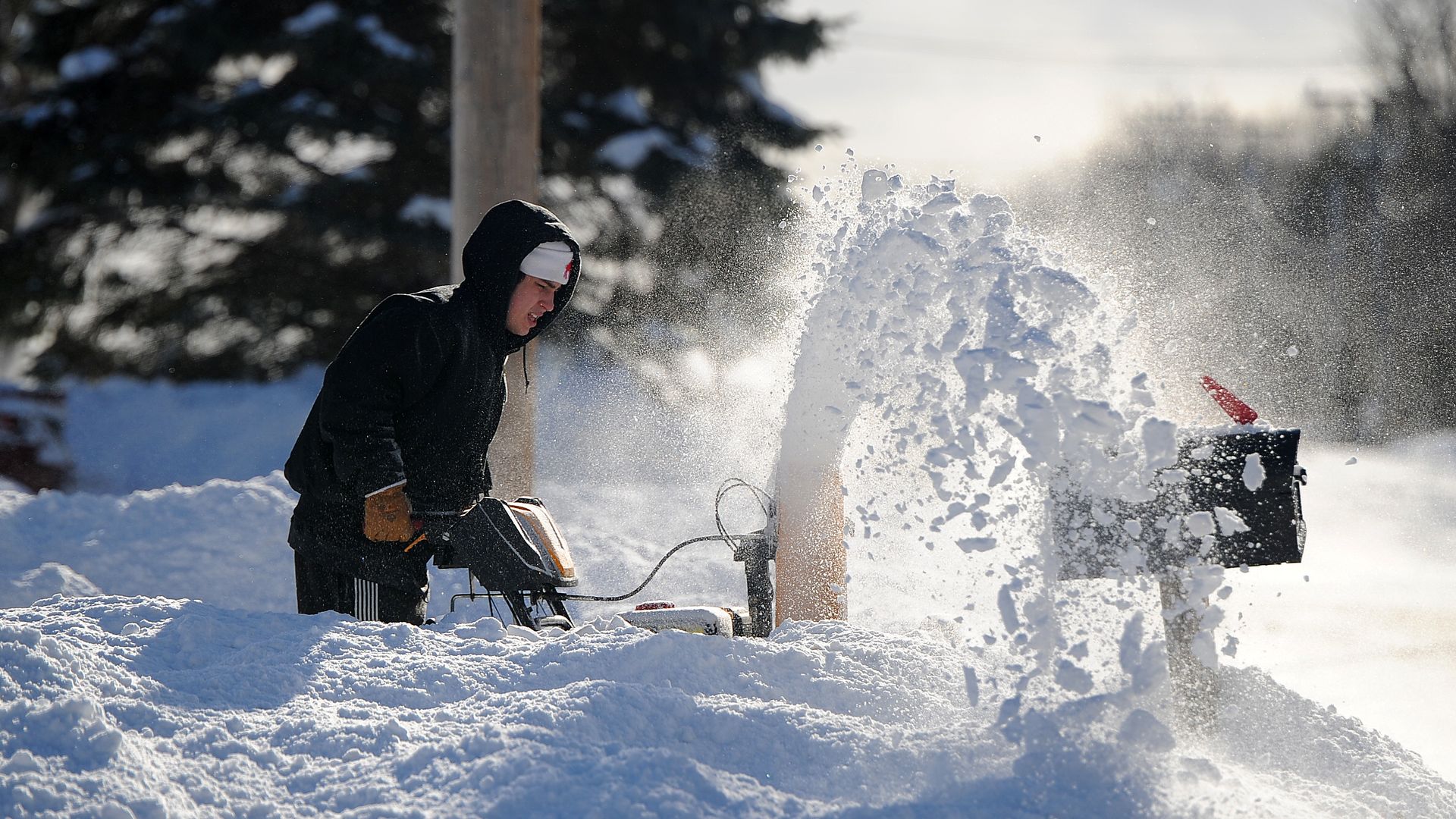 Drew Ahmed clears lake effect snow from his home January 1, 2026 in Lake View, New York. 