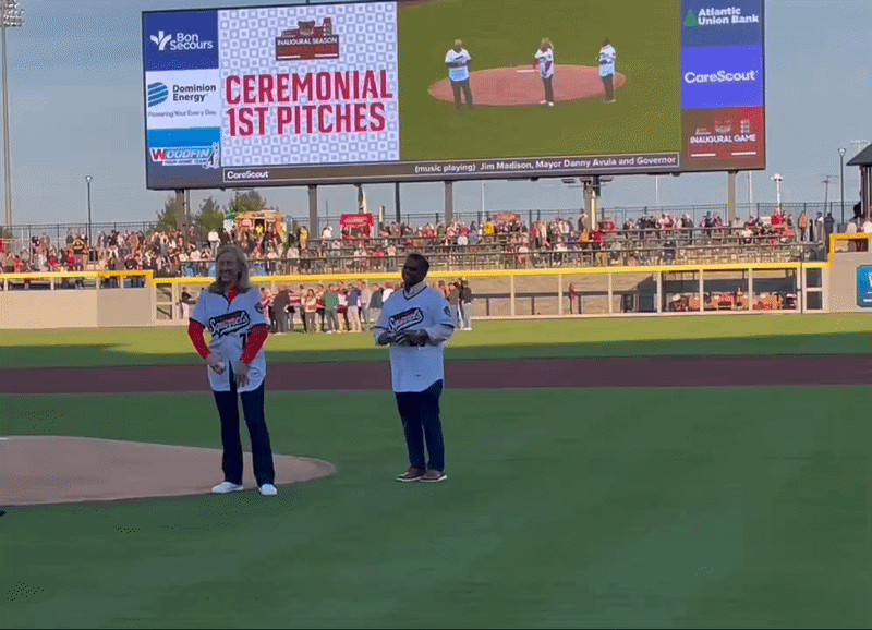 a video of governor spanberger and mayor avula throwing a ball on a baseball field