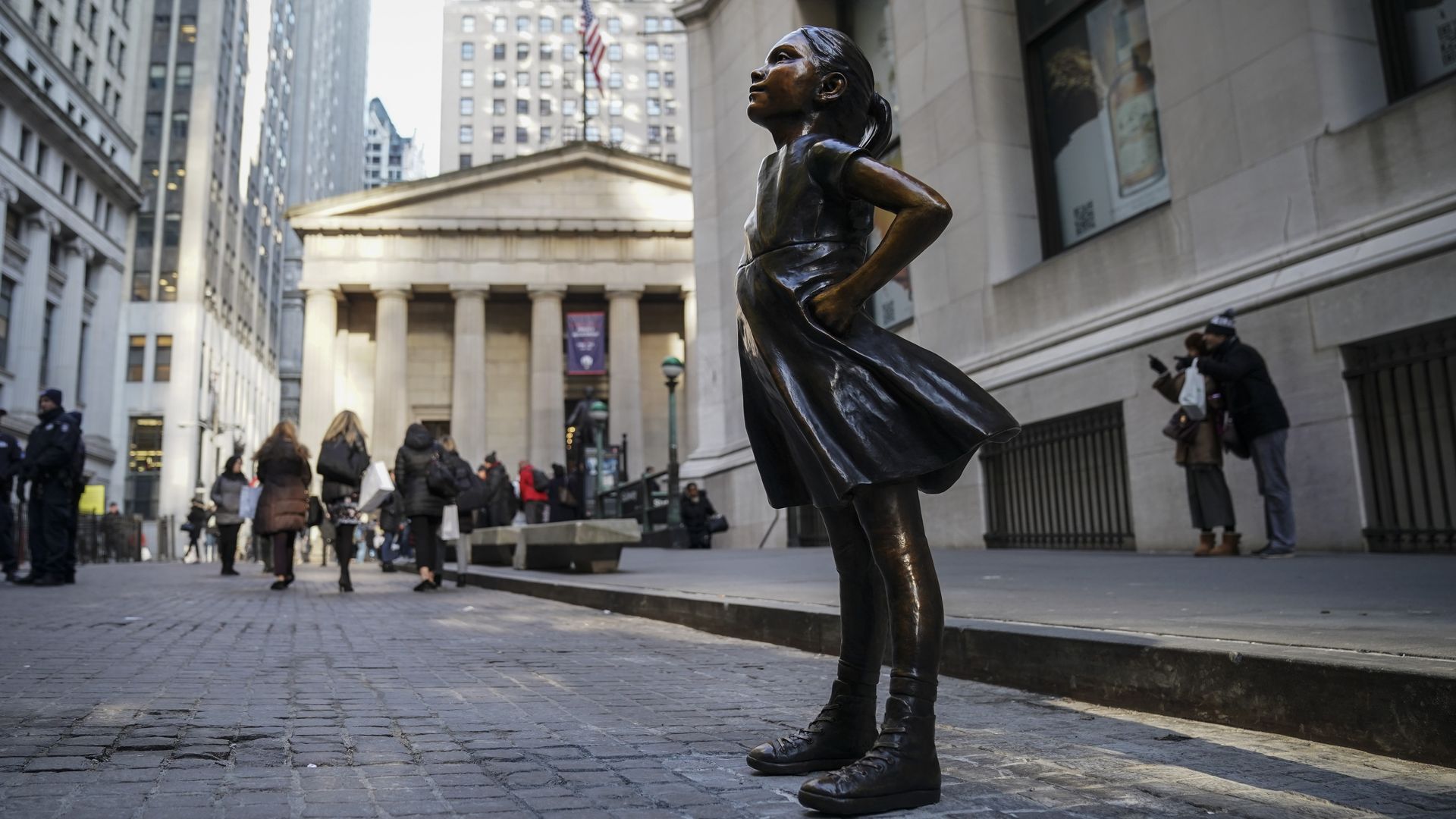Photo of a statue of a young girl standing defiantly