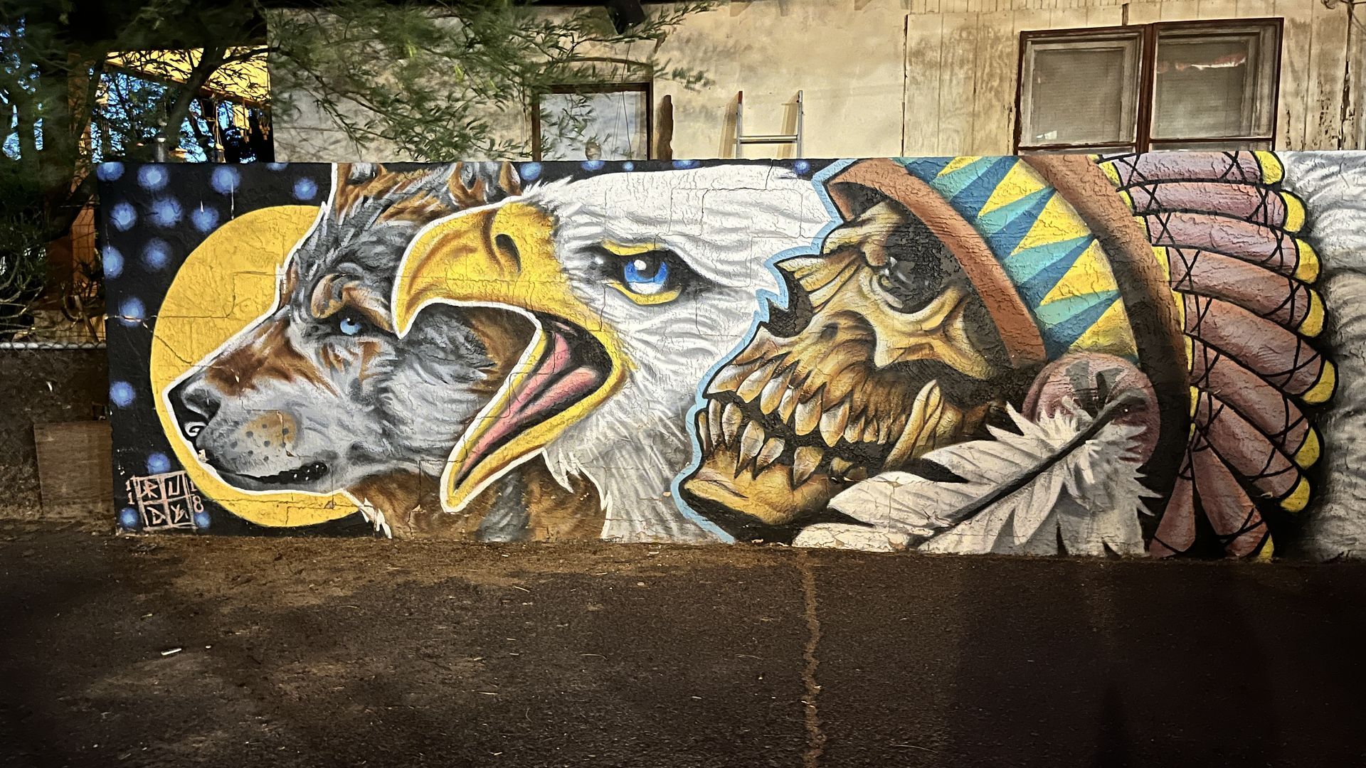 Mural in Phoenix with a wolf, eagle and skeleton