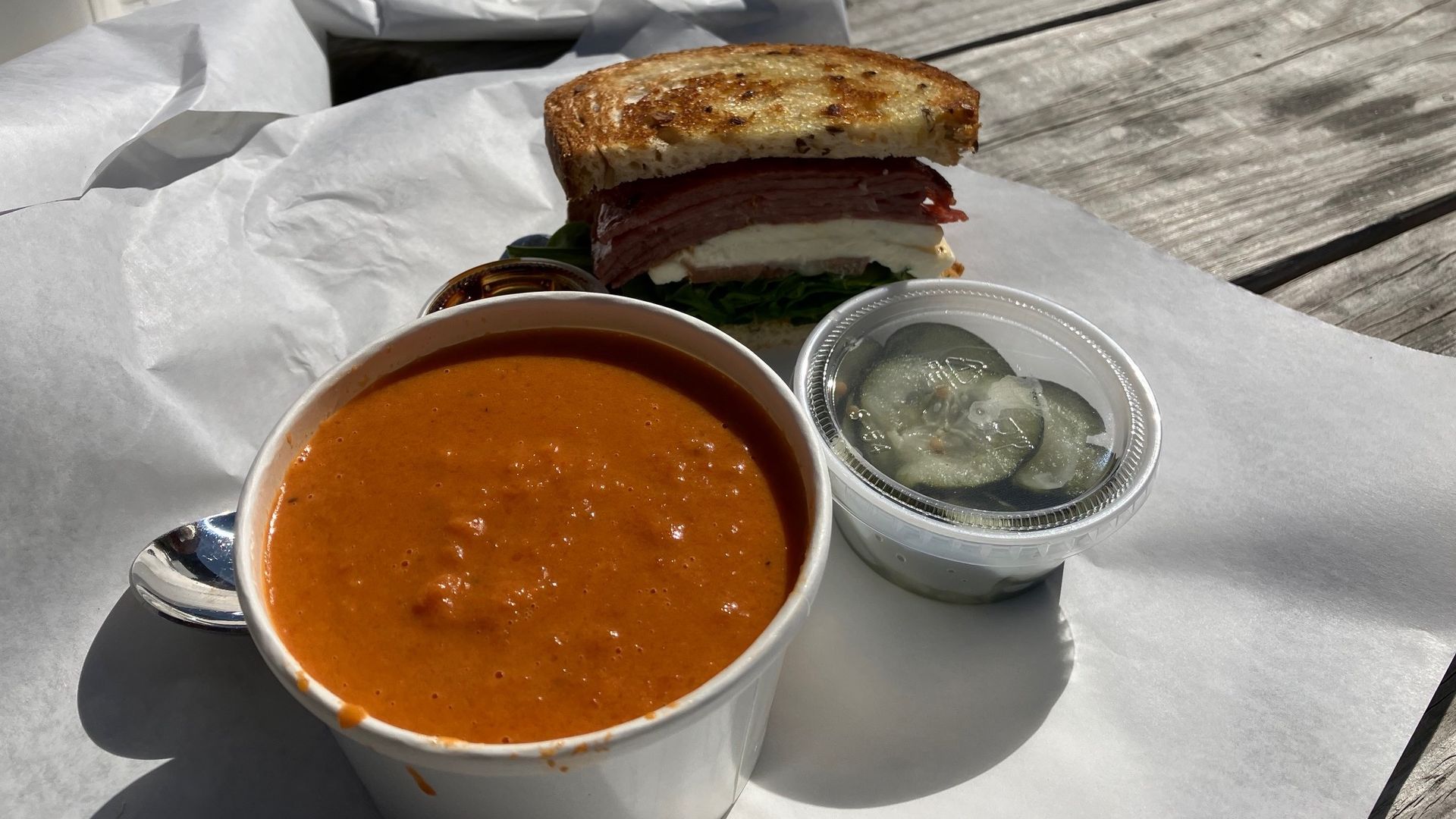 Tomato-coconut soup and pickles and a sandwich from FoodHeads.
