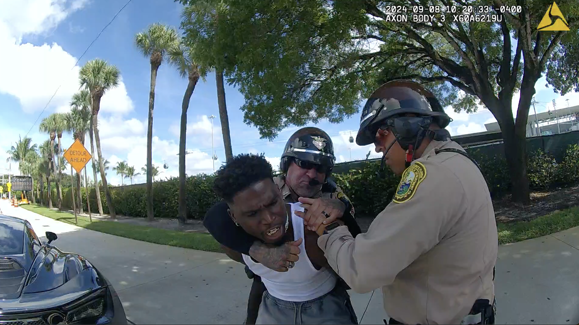 Dolphins player Tyreek Hill is forced to the ground during a traffic stop.