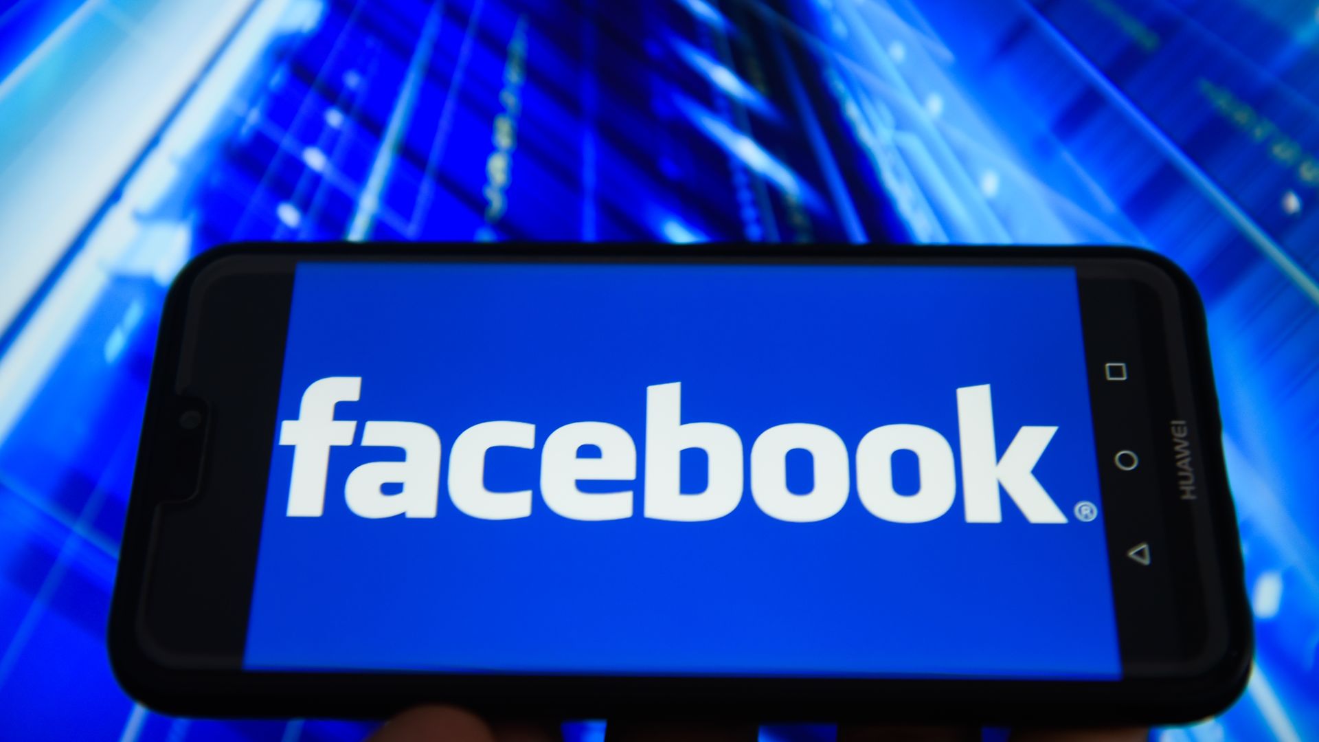 Facebook logo spelled out horizontally on a phone.