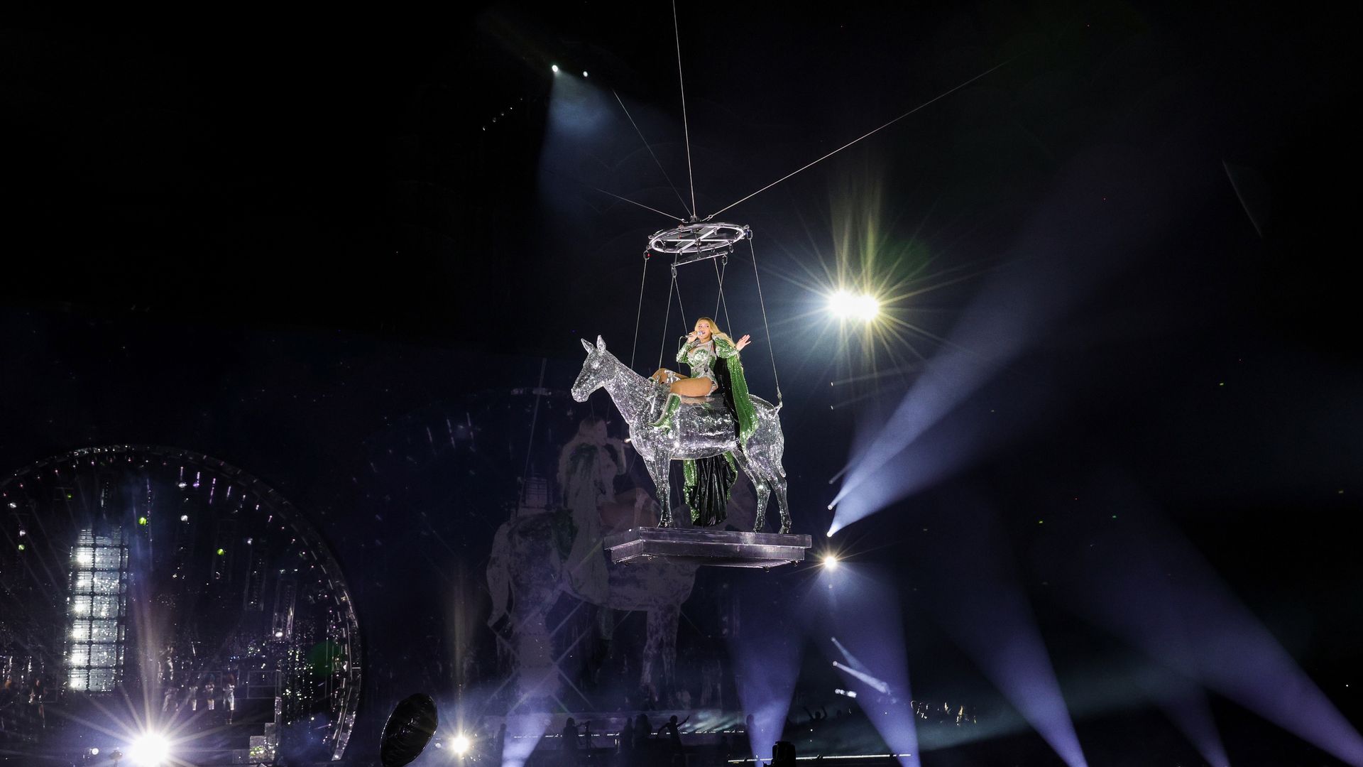 Photo of Beyonce on a disco horse mid-air. 
