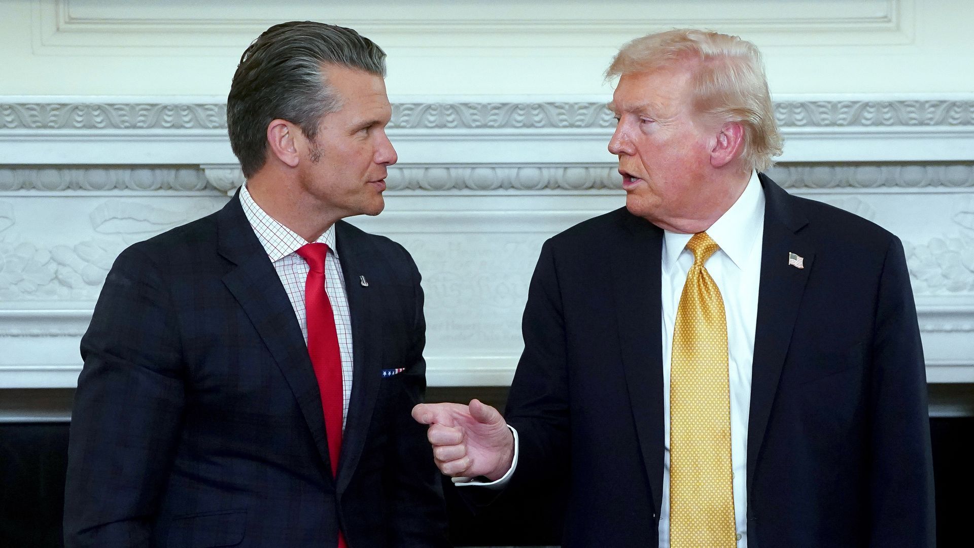 Hegseth, left, wearing a navy jacket, white striped shirt and red tie. Trump, right, wearing a navy jacket, white shirt and yellow tie. 