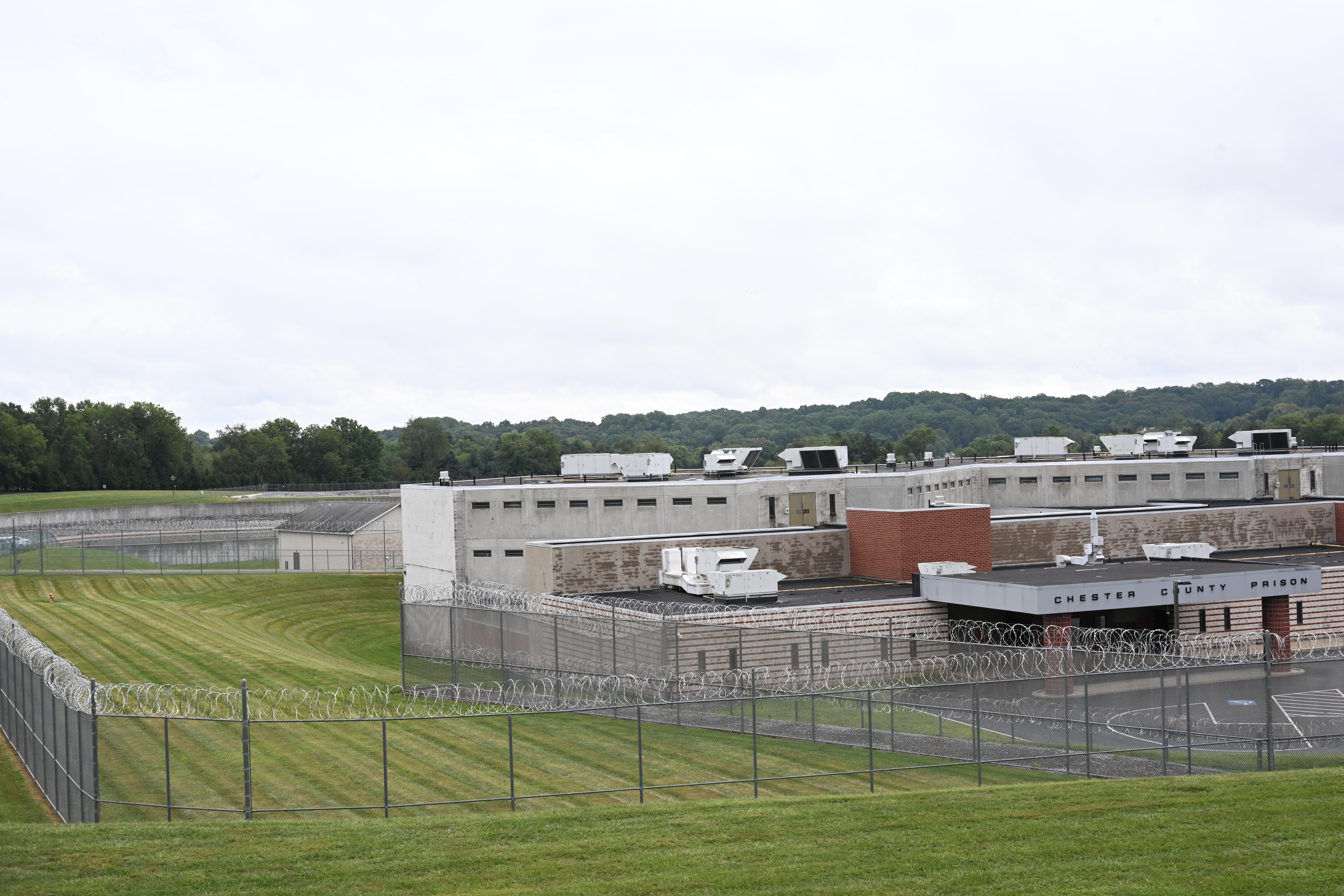 An aerial photo of the Chester County Prison plus its yard and razor-wire fence surrounding the property.