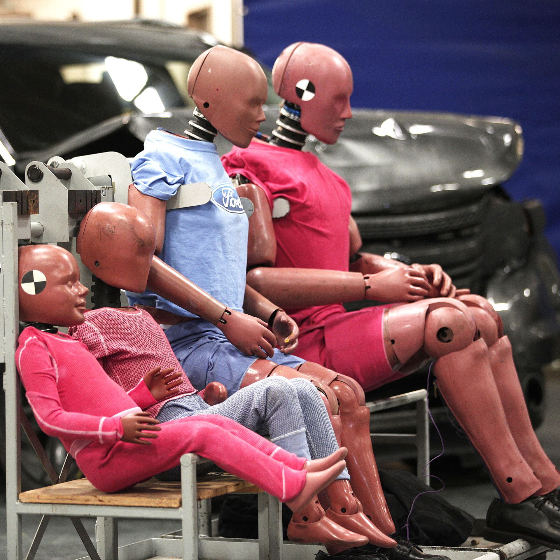 a family of crash test dummies at an auto testing site