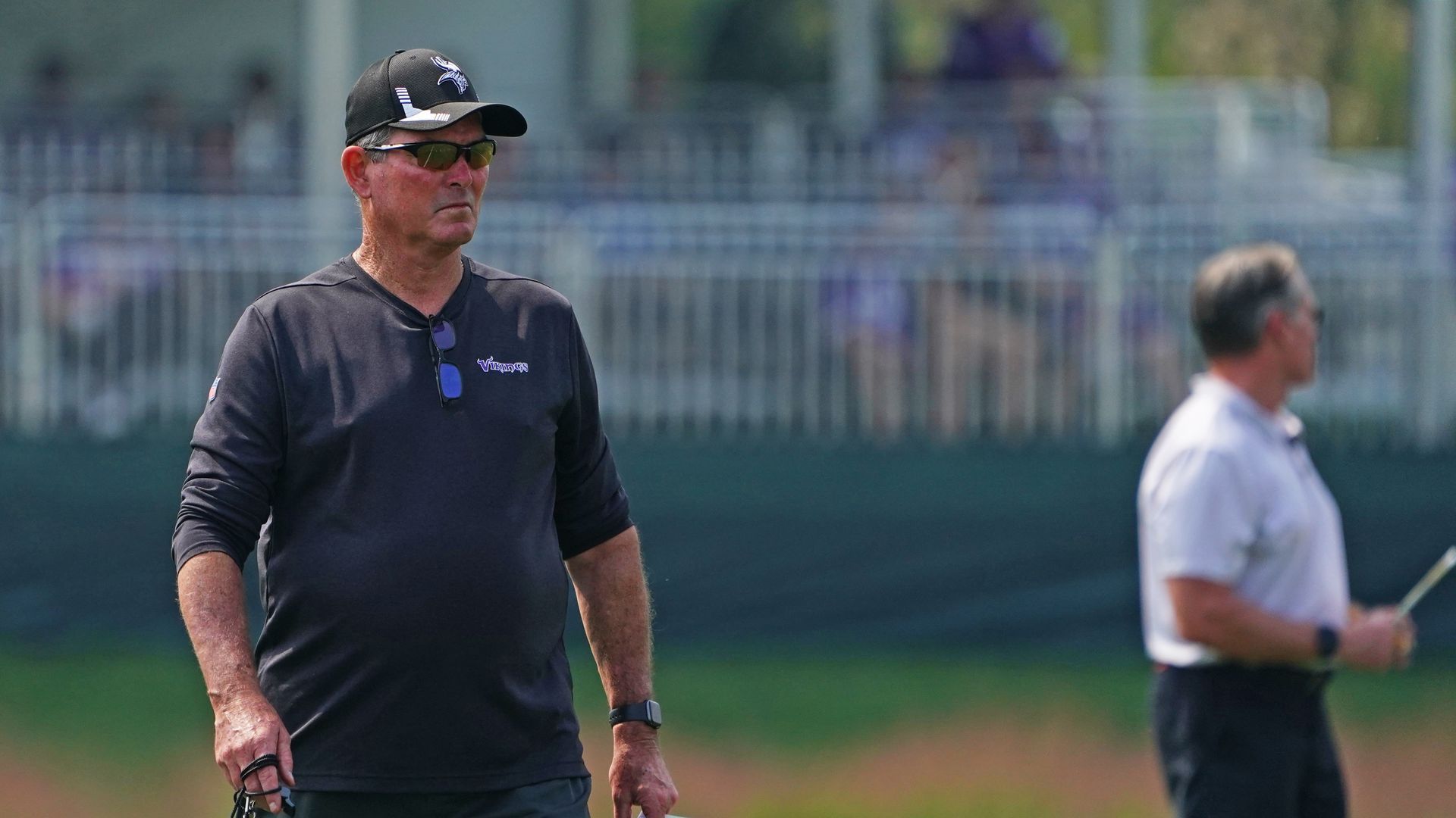 Minnesota Vikings head coach Mike Zimmer wears sunglasses while watching practice.