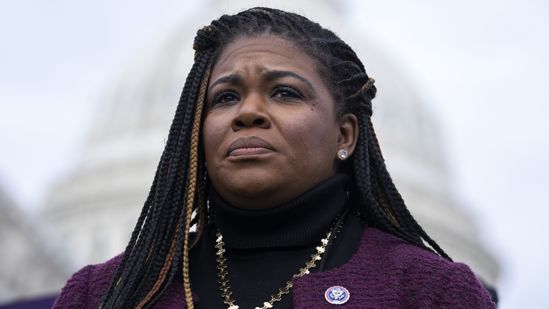 Rep. Cori Bush is seen standing in front of the U.S. Capitol.