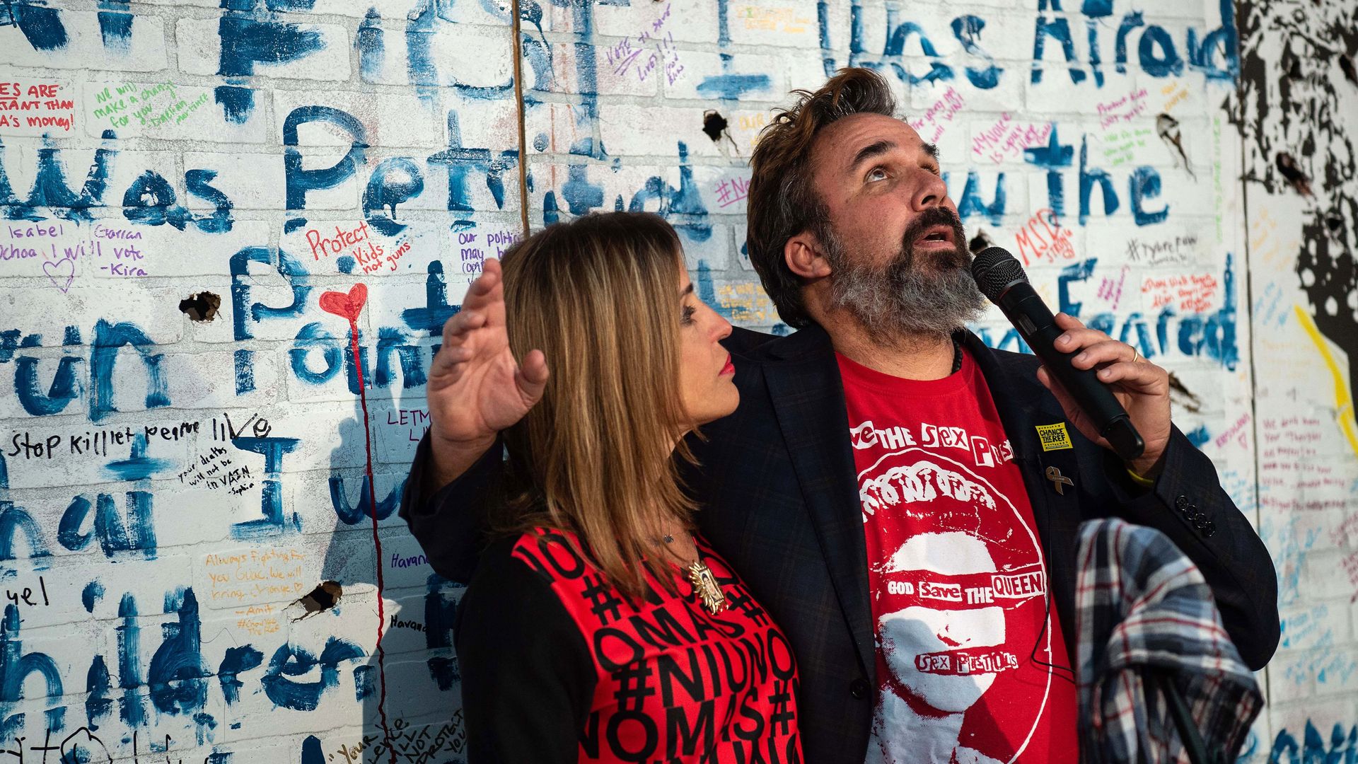 Artist and anti-gun activist Manny Oliver and wife Patricia (C), the parents of Stoneman Douglas High School shooting victim Joaquin Oliver, speak during the opening of the "Walls of Demand" exhibition to mark the first anniversary of the shooting at the Center for Contemporary Political Art in Wash