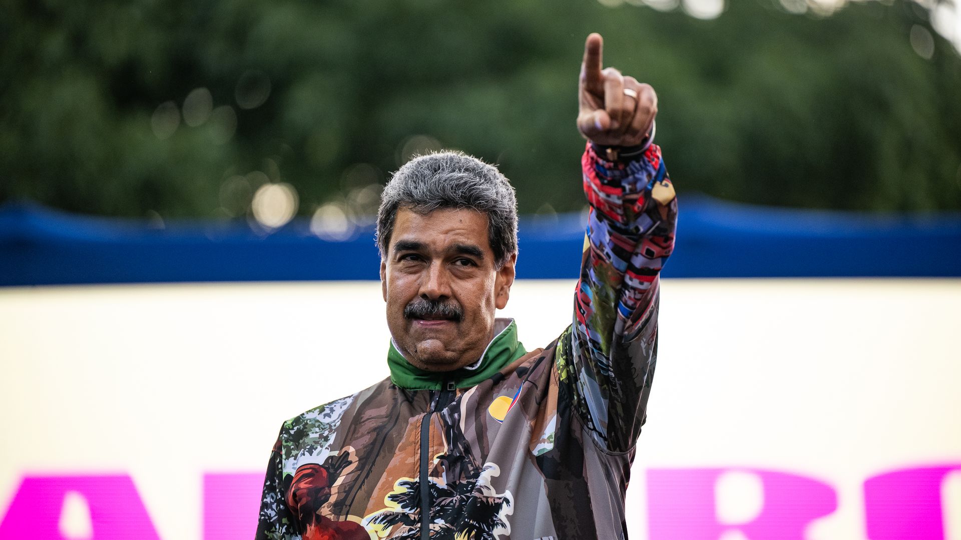 President of Venezuela Nicolas Maduro rises his hand during a mass gathering convene by supporters on July 18, 2024 in Caracas, Venezuela. 
