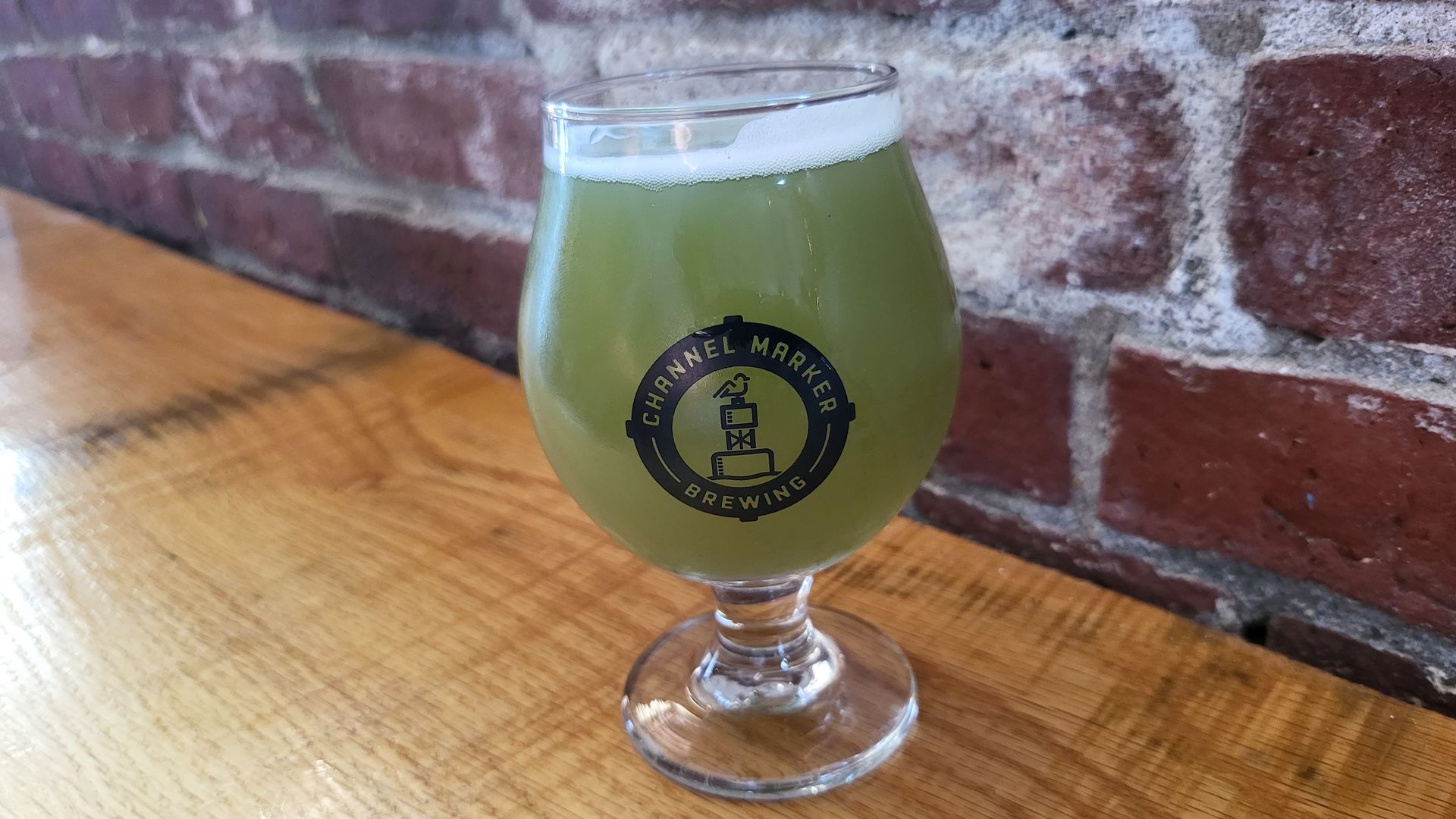 A green-colored beer in a glass.