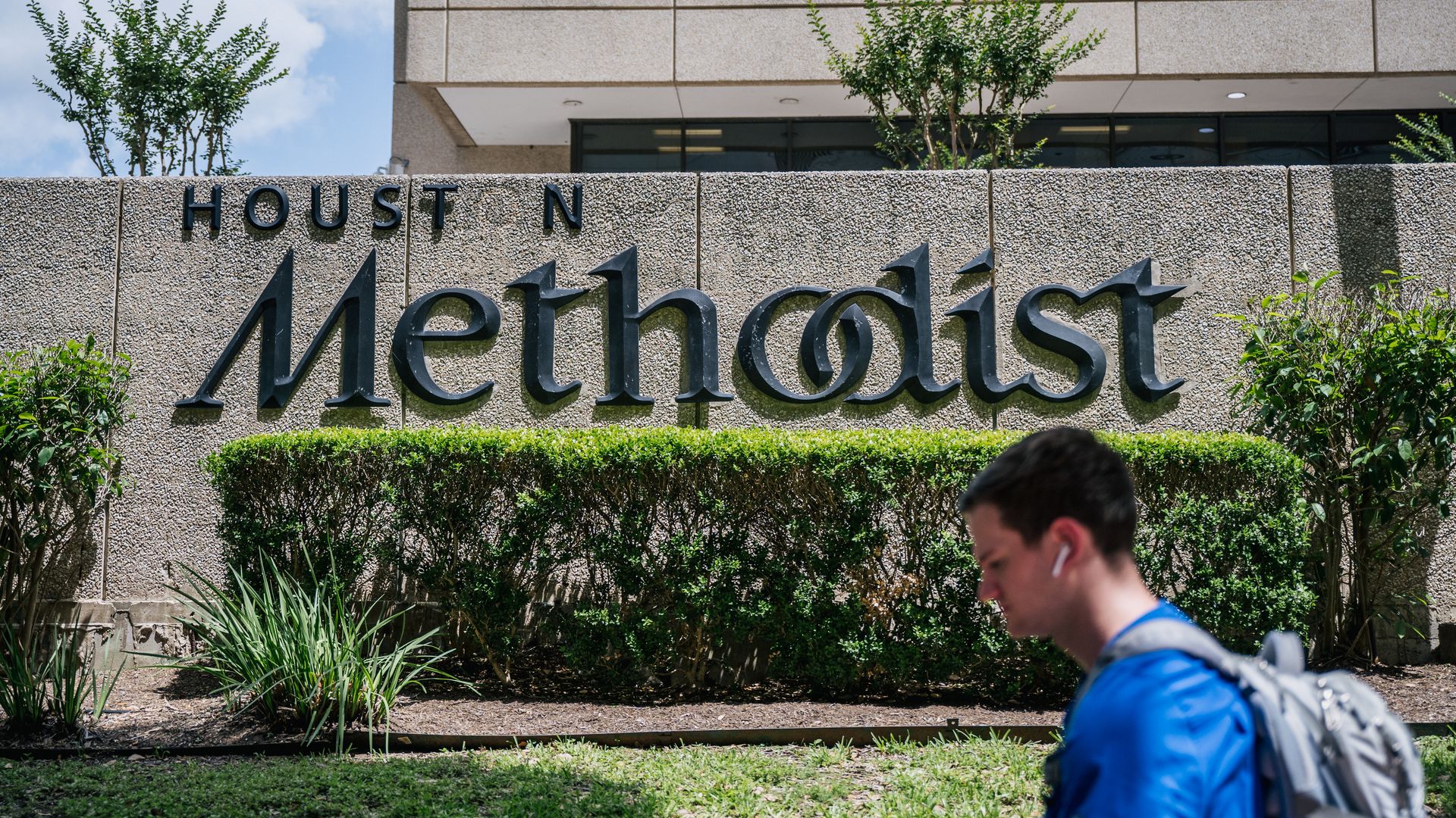 A man walks past the Houston Methodist Hospital on June 09, 2021 in Houston, Texas.